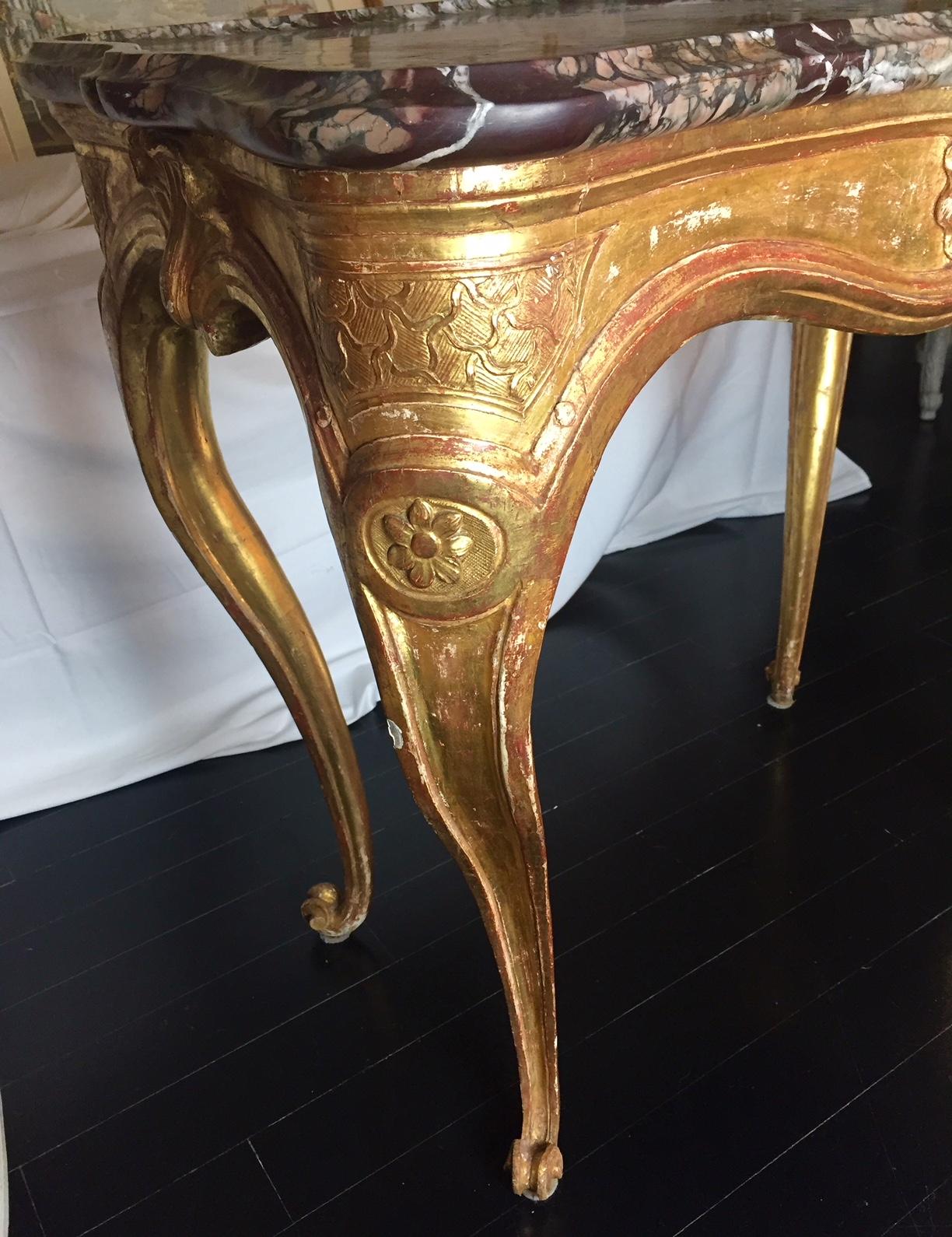 Rare and fine French Louis XV 18th century gilt gesse centre table with beautiful marble tray top. The table has a stylised shell decorated frieze, stands on cabriole legs with further cartouche decoration and terminates in perfectly curved feet.