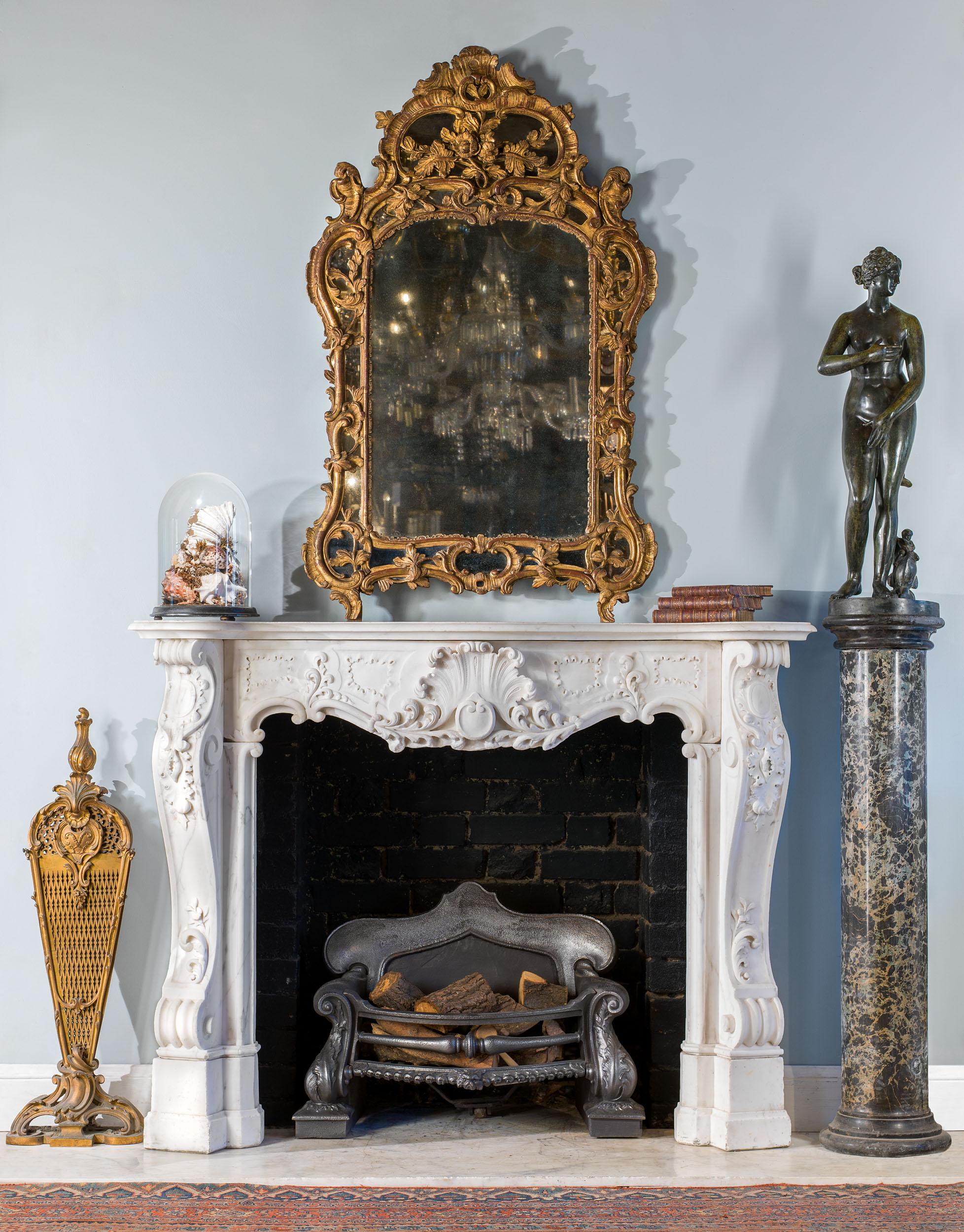 A fine French giltwood wall mirror, the gilded frame carved with scrolls and foliate flourishes over a wide mirrored border.

Southern French (possibly Provence), circa 1770 with restorations.
 