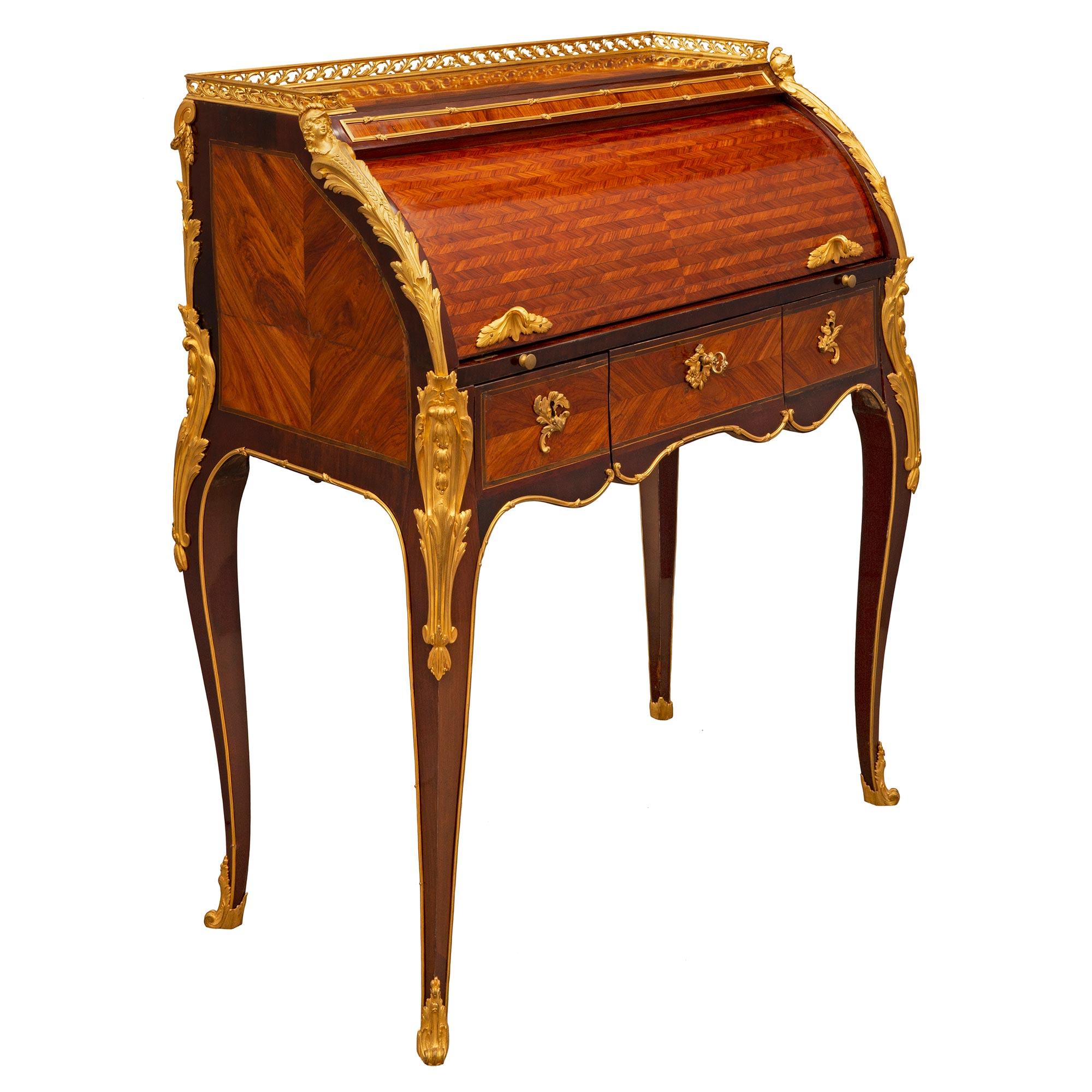 A most elegant and extremely high quality French 18th century Louis XV period Kingwood, Tulipwood, and ormolu desk circa. 1750. The Bureau à Cylindre desk is raised by beautiful cabriole legs with fine fitted scrolled foliate ormolu sabots and