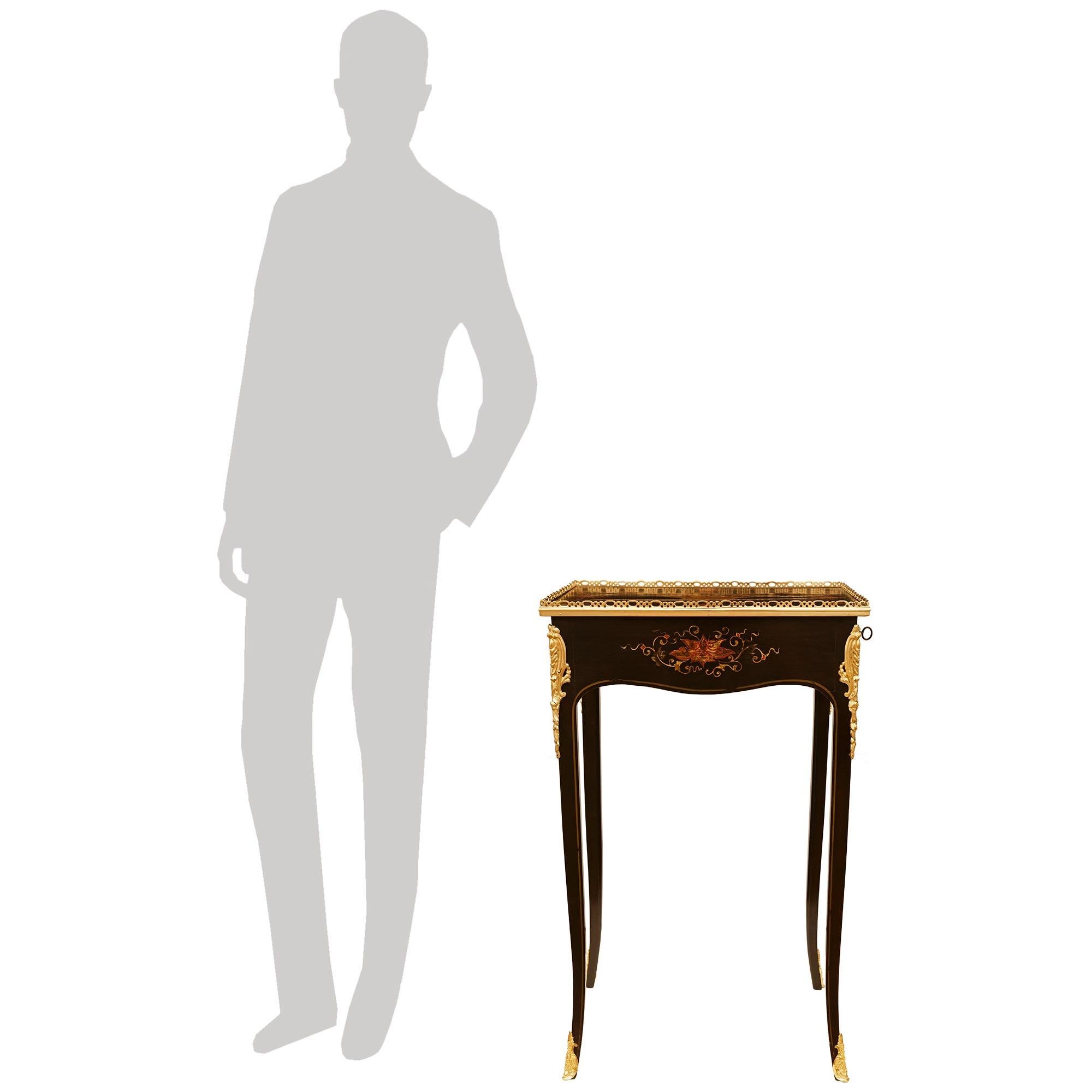 An elegant and most decorative French 18th century Louis XV Period Japanese Lacquer and Ormolu side table, circa 1750. This exquisitely detailed rectangular shaped table is raised on tall and slender cabriole legs ending with foliate Ormolu sabots.