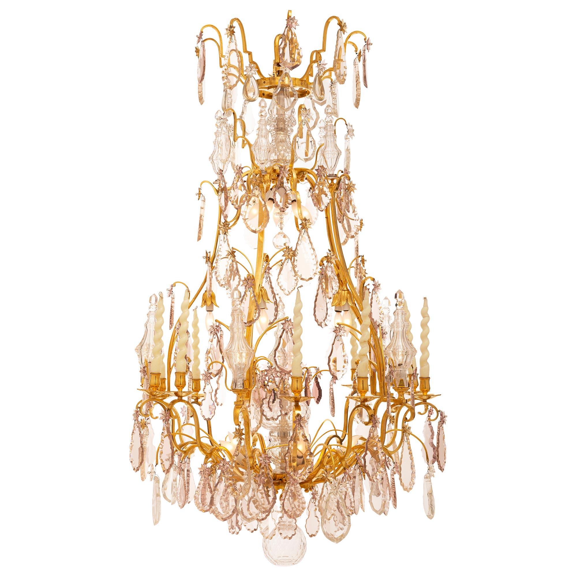 A sensational and extremely high quality French 18th century Louis XV period ormolu and crystal chandelier. The chandelier is centered by a charming and finely cut hand blown crystal ball below a tier of cut crystal pendants. Each of the fifteen
