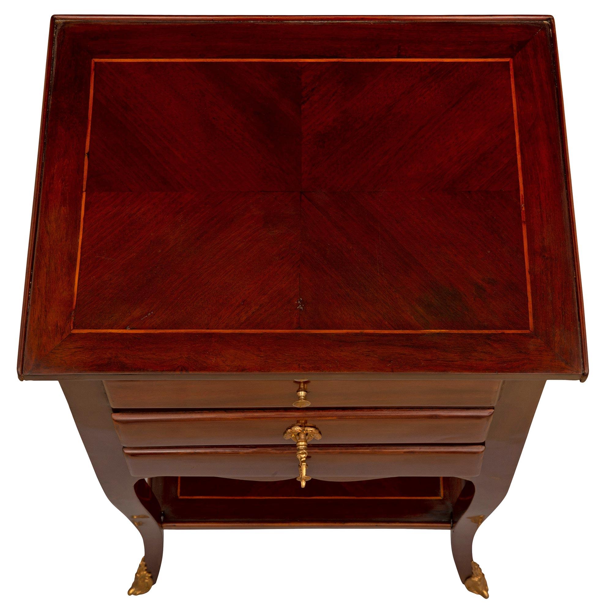 Charmante table d'appoint d'époque Louis XV en bois de rose et bronze doré vers 1750. La table de petite taille est surélevée par d'élégants pieds cabriole élancés avec de jolis sabots en bronze doré feuillagé et reliés par une fine étagère de fond