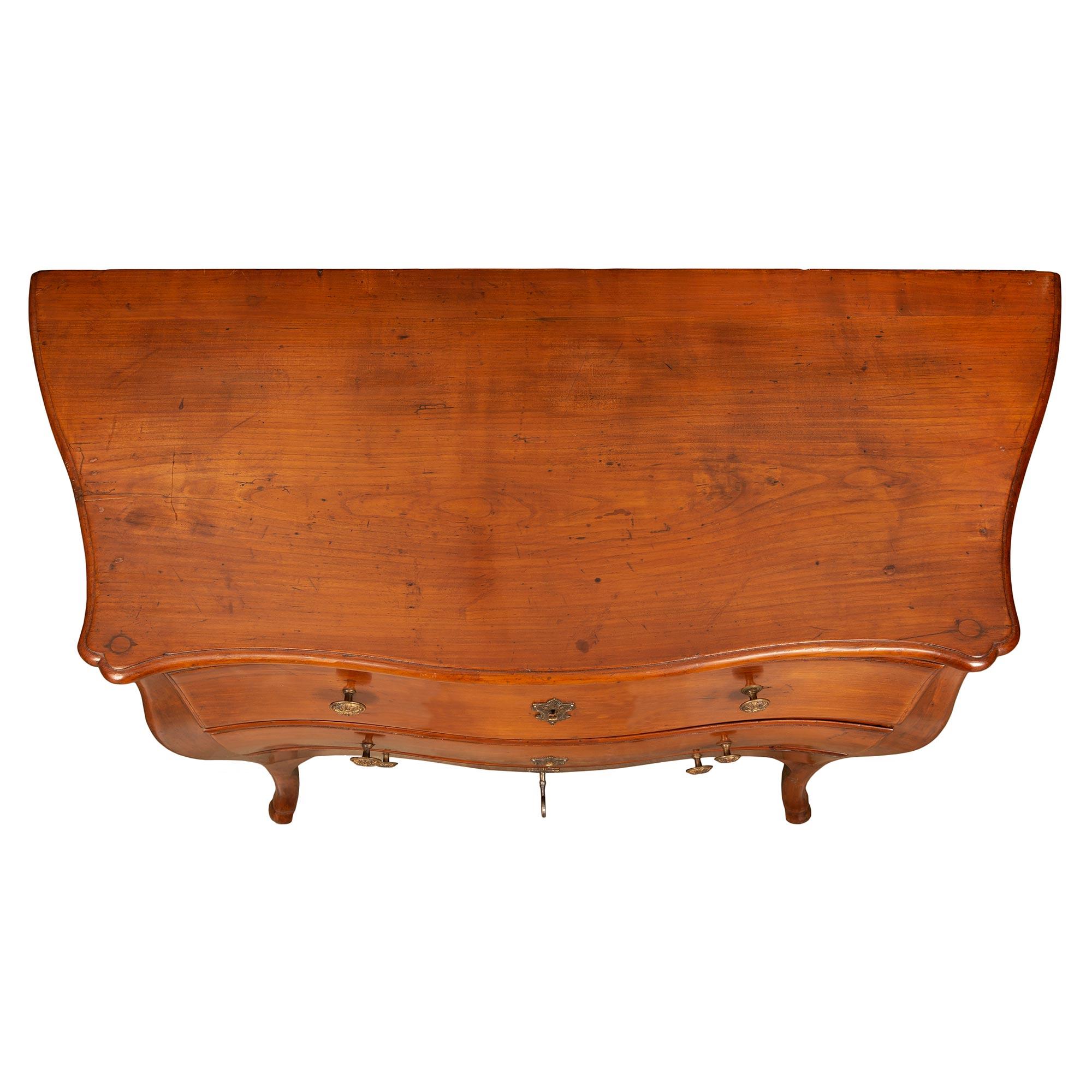 A most handsome French 18th century Louis XV period walnut petite commode Bordelaise. The chest is raised by elegant cabriole legs with carved hoof feet. Above the fine scalloped shaped frieze are three drawers. Each with a lovely bombee shape,