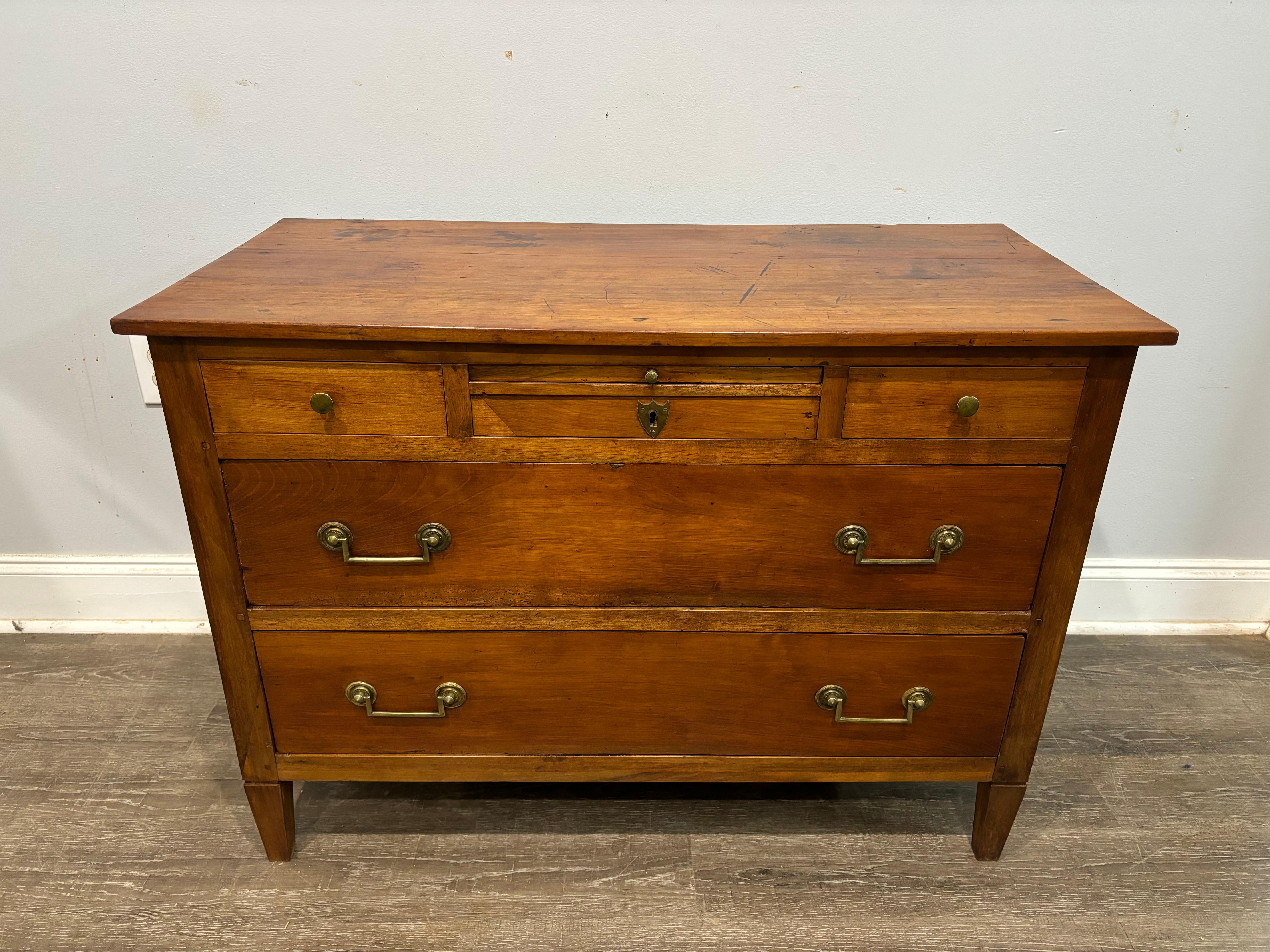 This 18th century Louis XVI Commode is made of walnut. It has a slider in the front which is unusual.