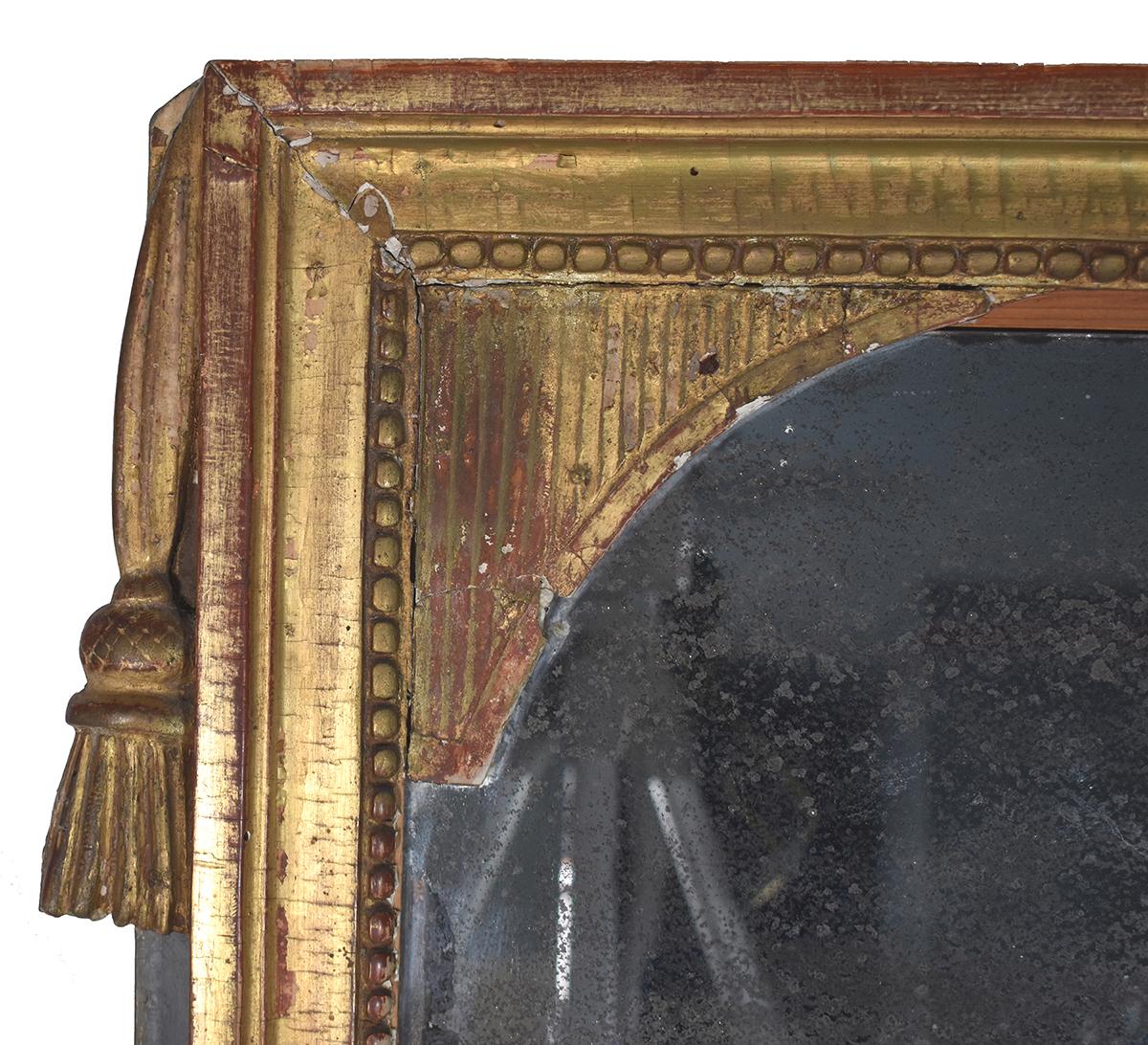 This French 18th century Louis XVI gold gilt mirror has detailed neoclassical tassel carving. Could be the original mirror but unsure of age.
   