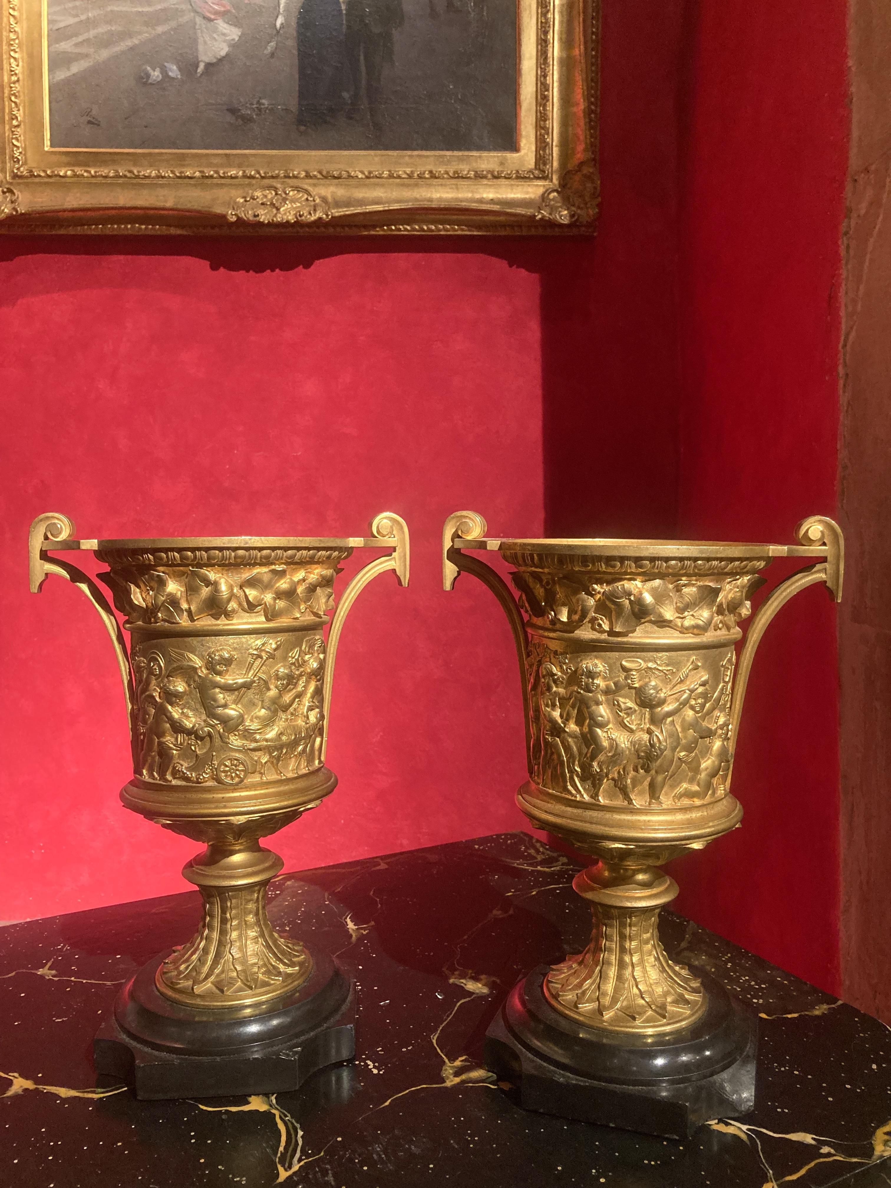 This pair of French Louis XVI ormolu handled vases date back to late 18th century (1700s) These exceptional camapana urn shaped gilt bronze vases were created with the ancient traditional technique of the lost-wax casting (à la cire perdue) and