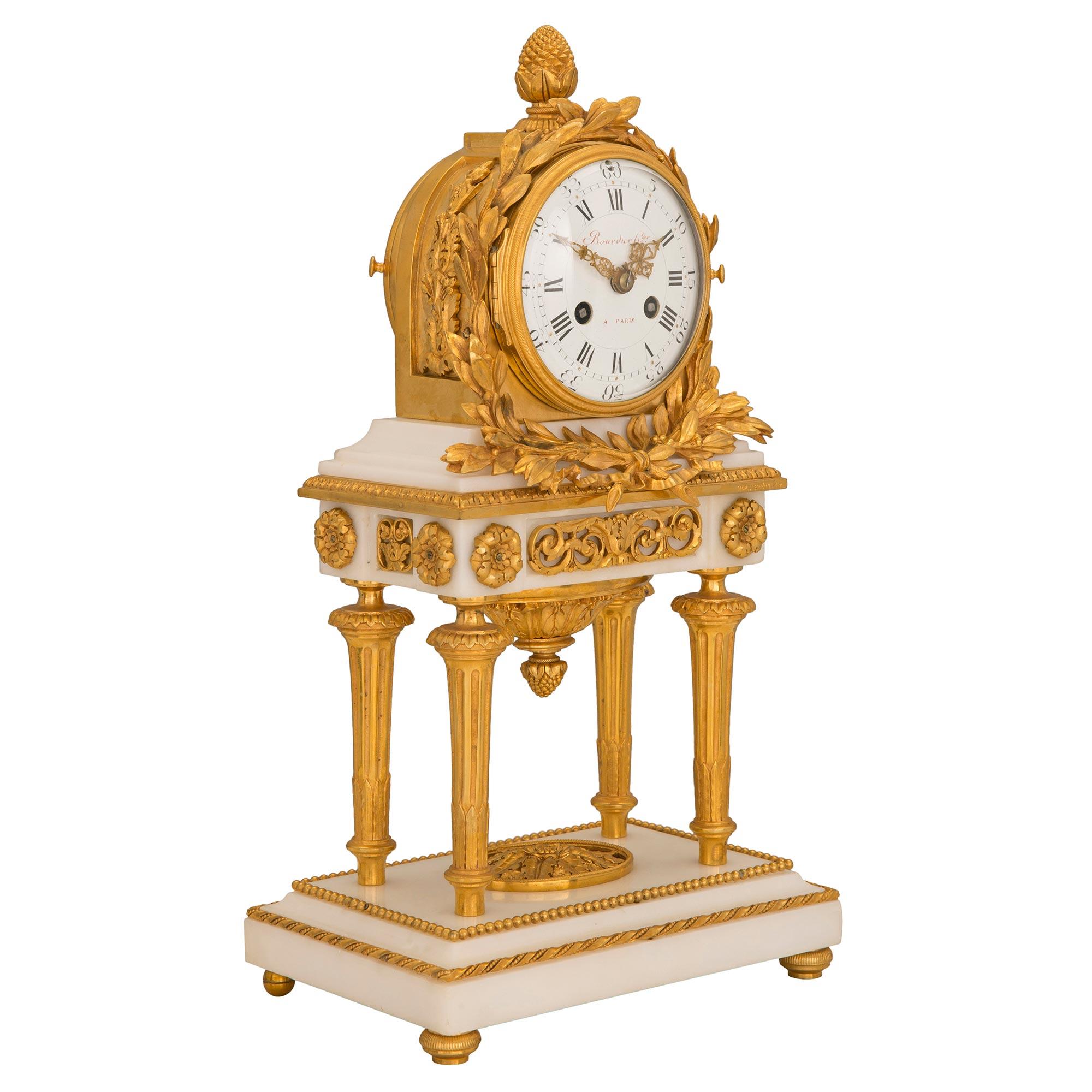 A striking and high quality French 18th century Louis XVI period white Carrara marble and ormolu garniture clock set signed by Jean-Simon Bourdier. The clock is raised by elegant mottled reeded feet below the rectangular white Carrara marble base