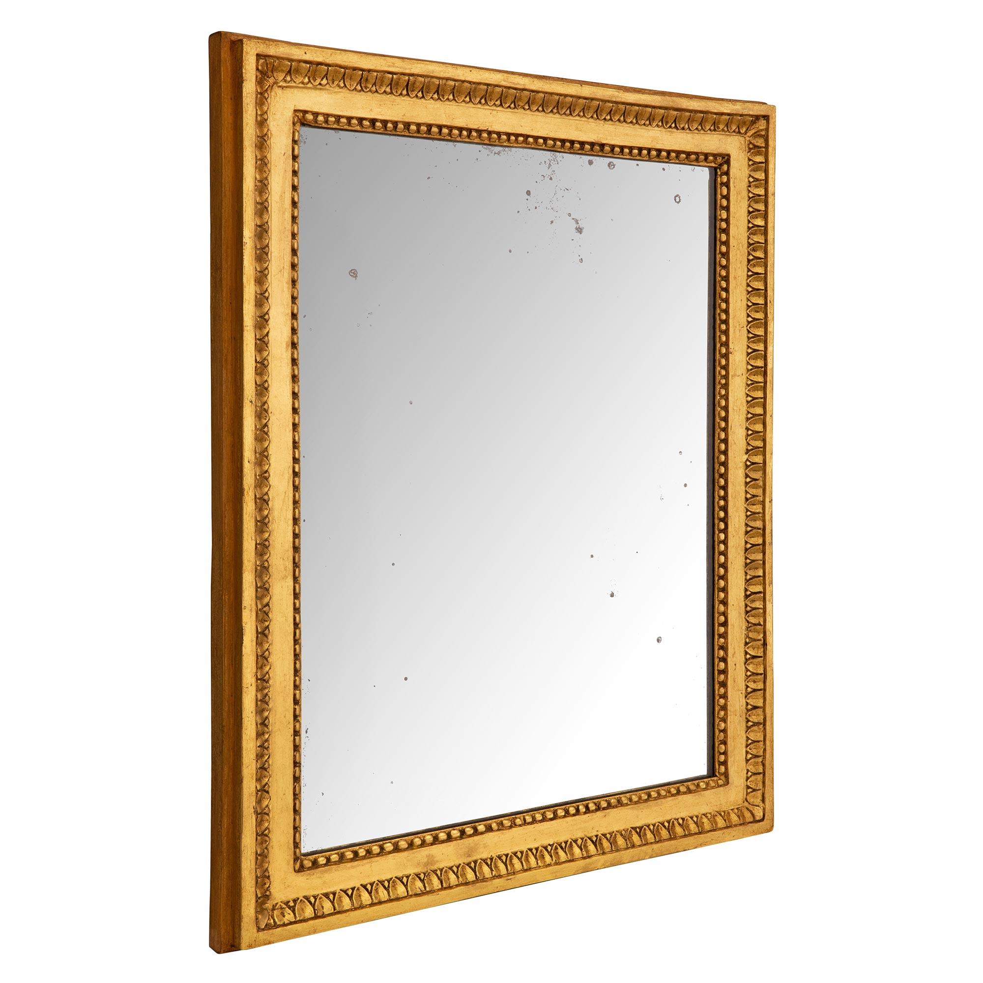A most elegant French 18th century Louis XVI period giltwood mirror. The mirror retains its original mirror plate set within the beautiful mottled giltwood frame with a fine beaded border and a richly carved foliate wrap around band. Can be