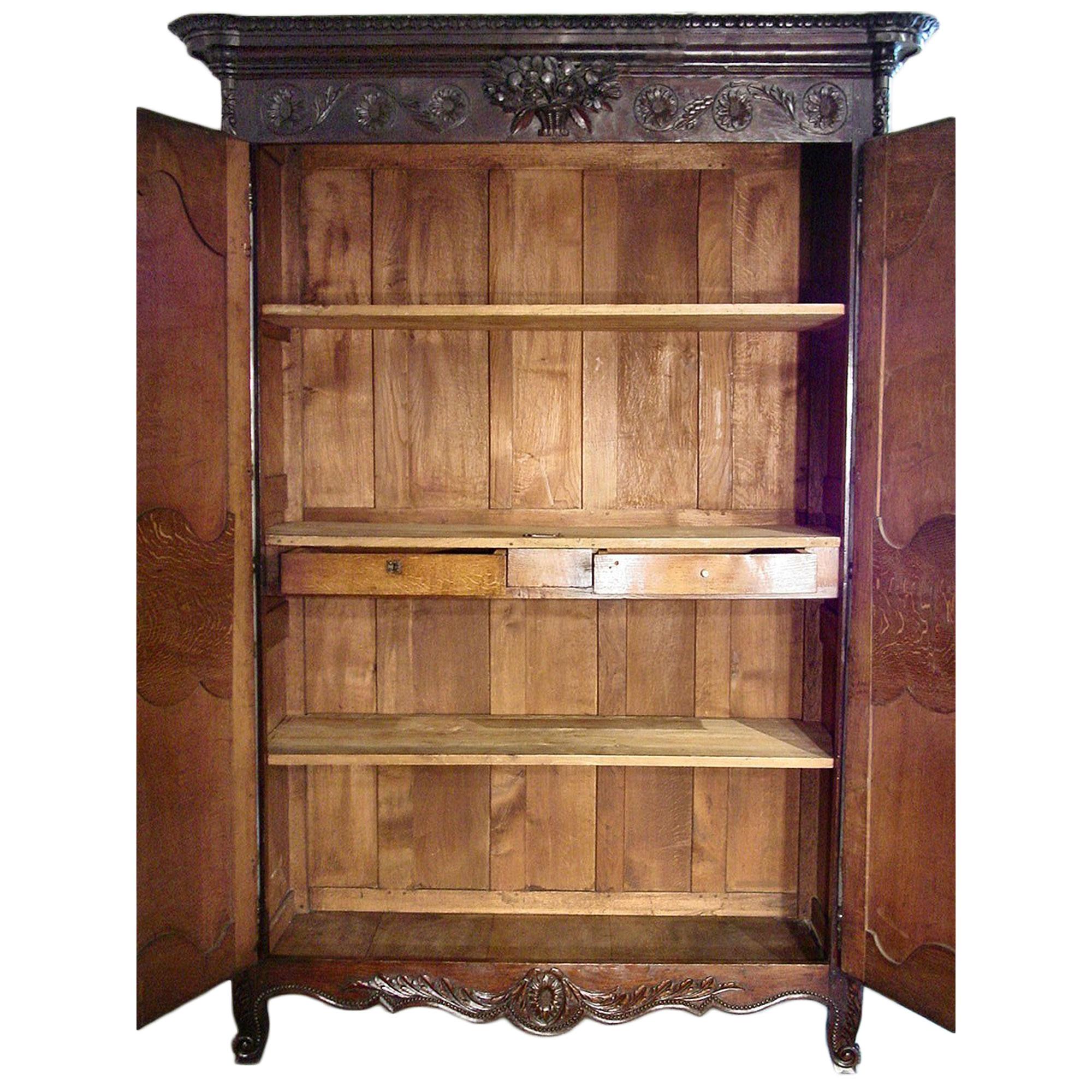 An exceptional and extremely high quality, mid 18th century circa. 1750, French Louis XVI Period Normandy marriage armoire in dark Oak. The armoire with all original hardware including hinges going from the top to the bottom of the doors, has two