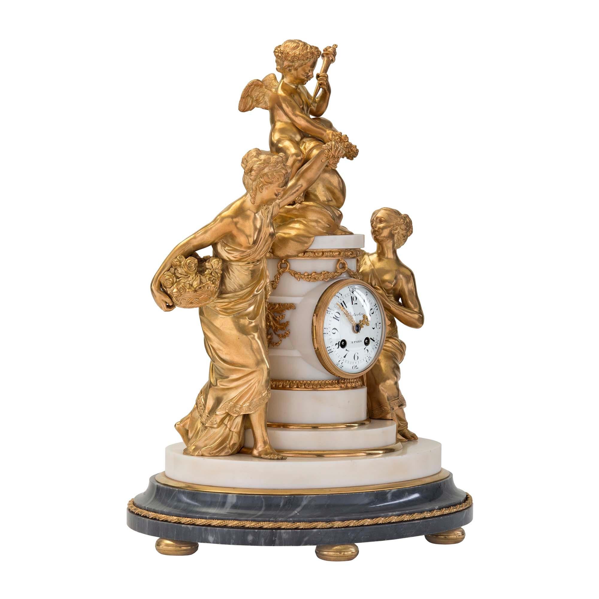 An extremely elegant and very high-quality French 18th century Louis XVI period ormolu, Bleu Turquin and white Carrara marble clock signed by Jean-Baptiste Dutertre. The clock is raised by six ormolu bun feet below the oval-shaped mottled Bleu