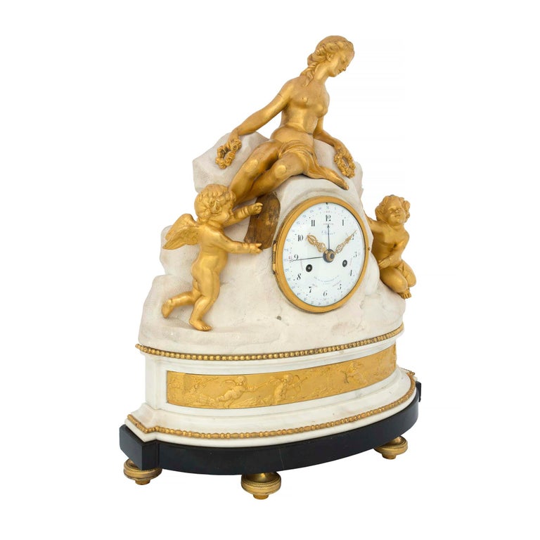 An incredible and extremely high quality French late 18th century Louis XVI period ormolu, white Carrara marble and black Belgian marble clock signed Déliau - Rue De La Bartillerie No. 24 A Paris. The clock is raised by etched topie shaped ormolu
