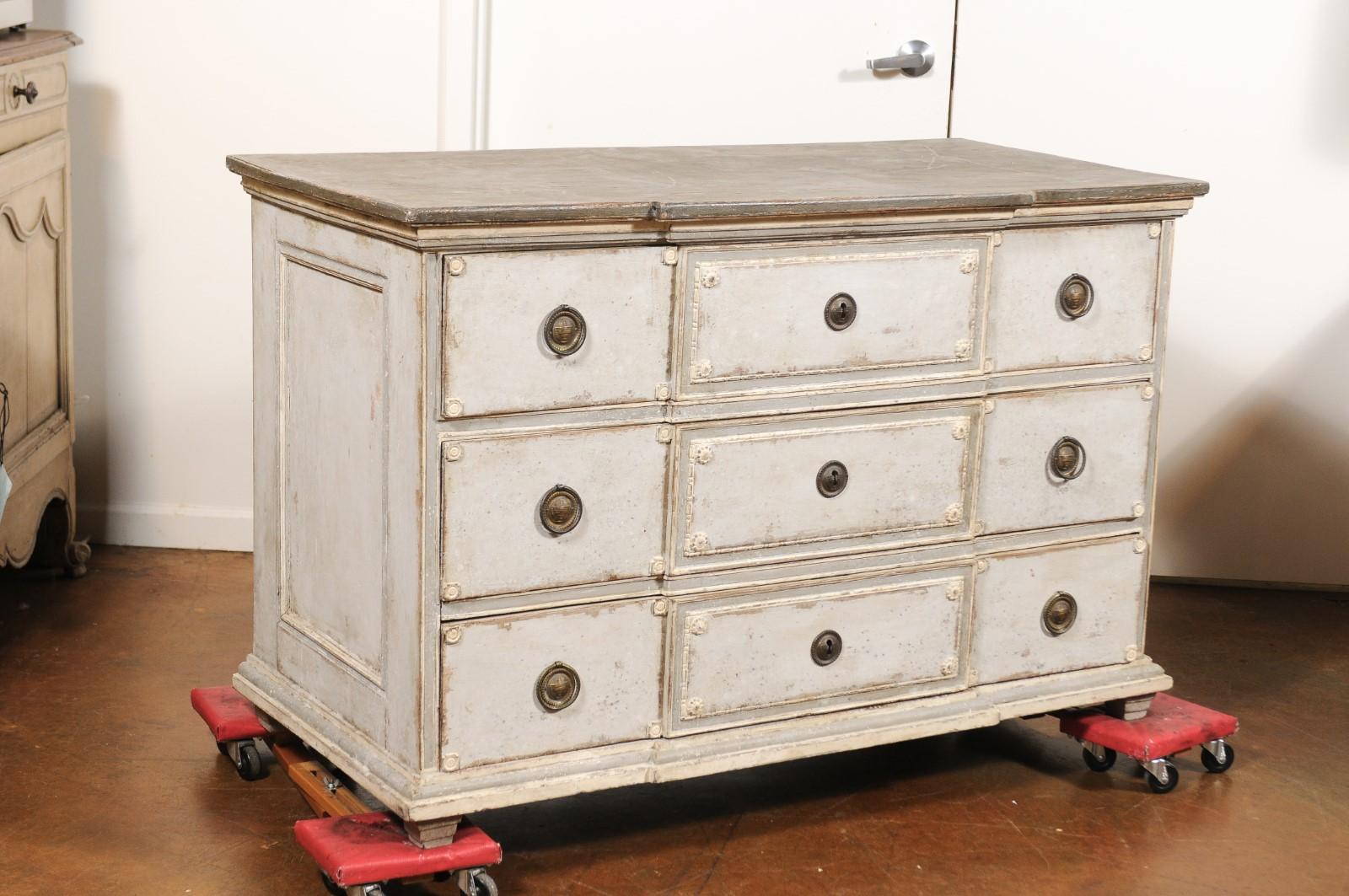 A French Louis XVI period painted three-drawer breakfront commode from the late 18th century. Born in the last quarter of the 18th century under the reign of France's last monarch of the Ancient Régime Louis XVI, this painted commode features a