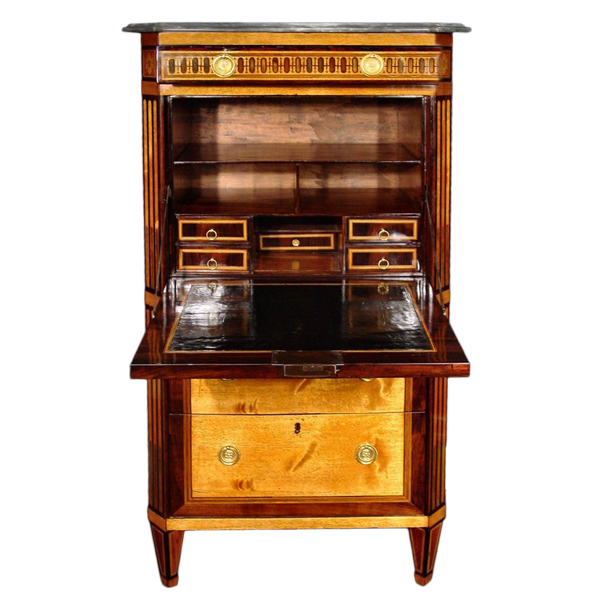 An elegant French 18th century Louis XVI period secretaire abattan. The secretary with two lower deep drawers is below the drop front designed with an intricate floral marquetry of exotic woods and mother of pearl. The fruitwood inlay is both on the