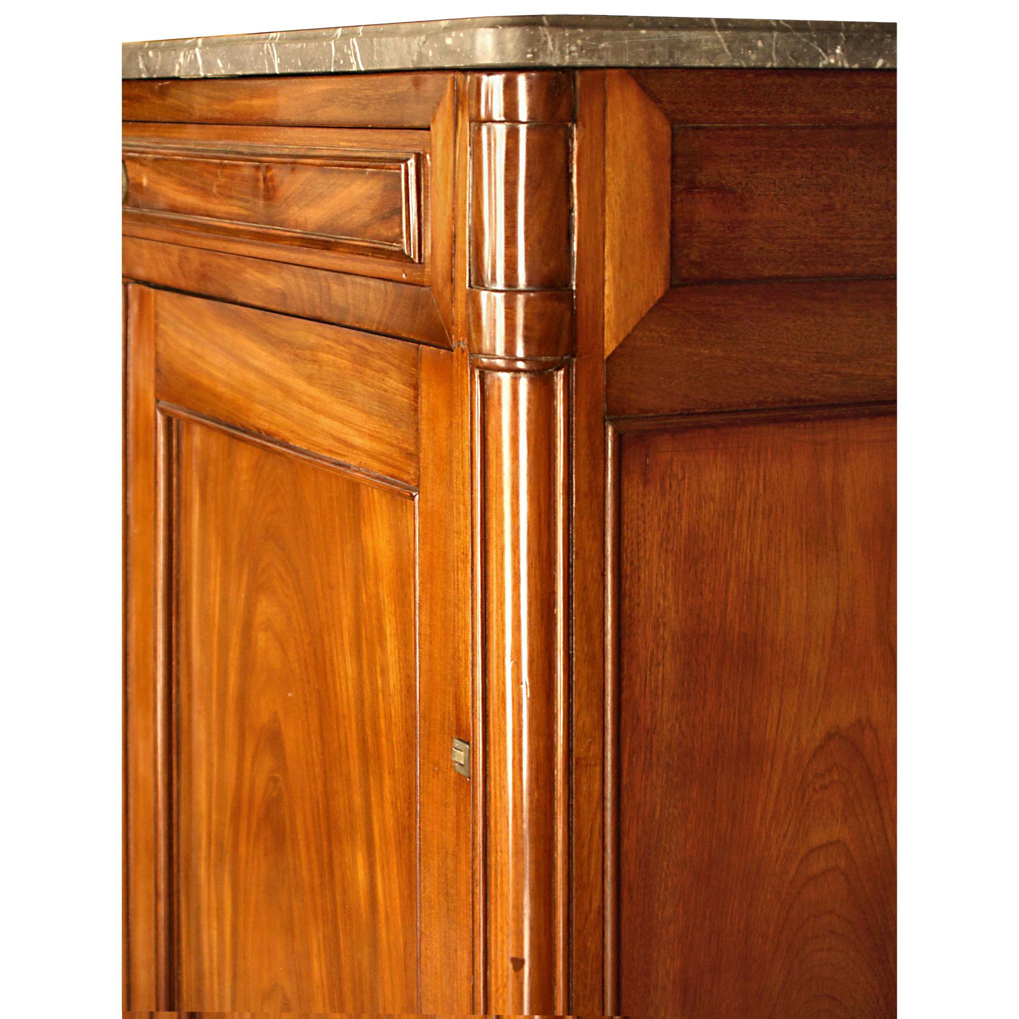 A very high quality and elegant French 18th century Louis XVI style solid Mahogany cabinet. Raised by a straight rectangular moulded base, the cabinet has two moulded paneled doors with very elaborate hardware including its original clover shaped