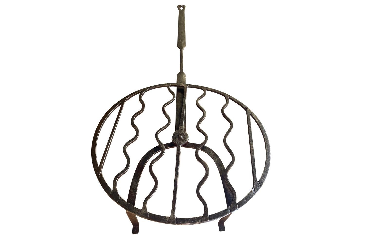 A wonderful 18th century Meat Cooker - Roaster from the Southwest of France.  Handsomely crafted in iron.  Pieces such as these were set in the fireplace and meat was placed on top to cook the meat.  The circular top rotates.  A terrific kitchen