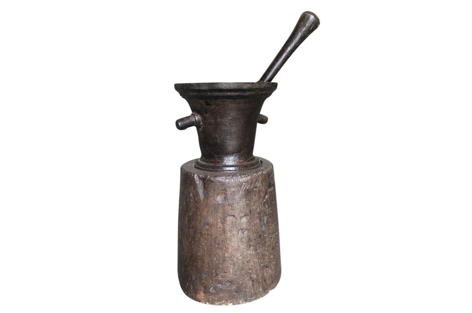 A sensational 18th century mortar and pestle in iron with its base constructed from a solid block of walnut. A stunning sculpture for any traditional or modern surrounding.