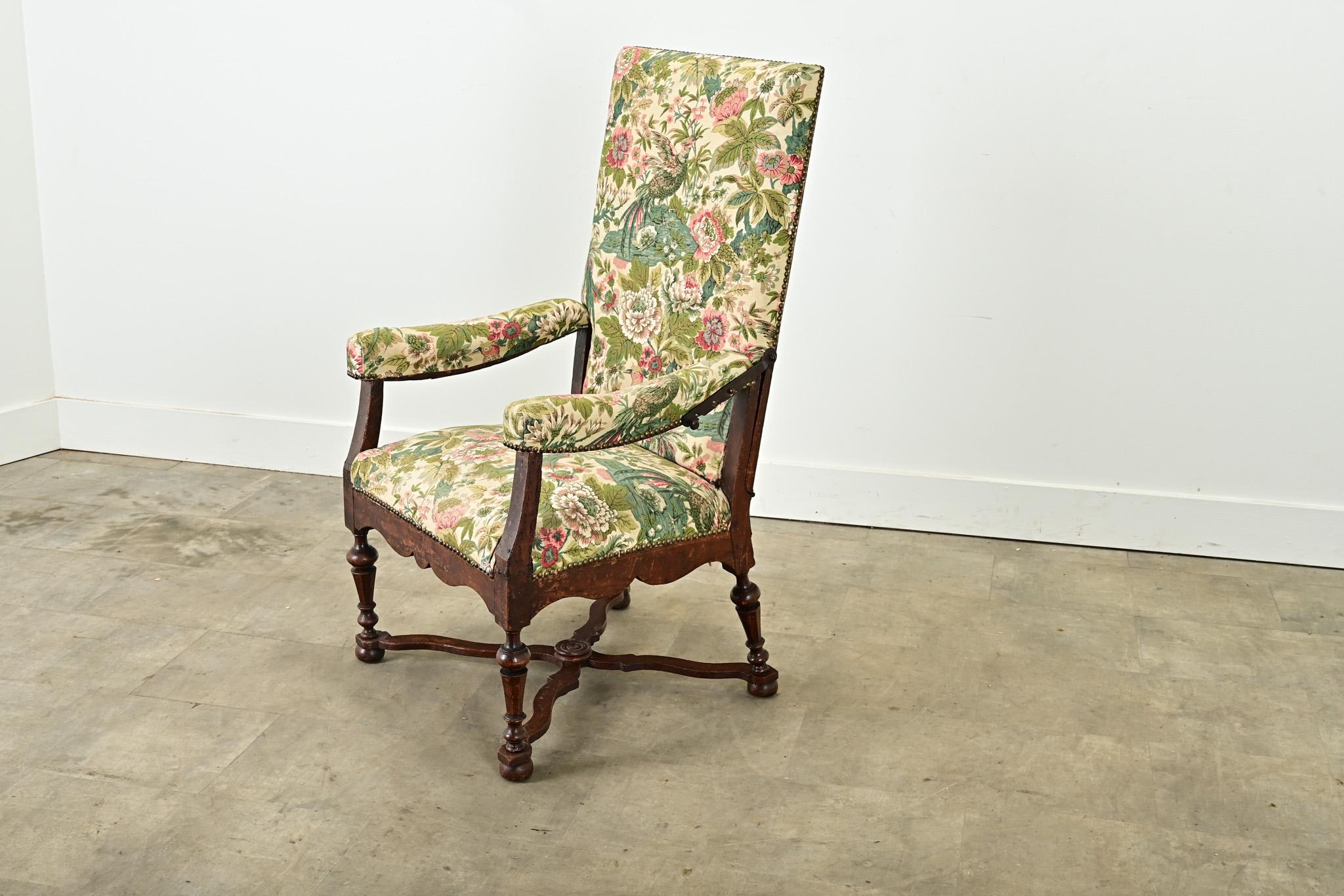 This rare French 18th century Louis XVI armchair reclines, and features a hand carved solid oak frame with shaped arms that curve down to the chair’s scalloped base and turned baluster legs. The high chair back reclines using two forged iron handles
