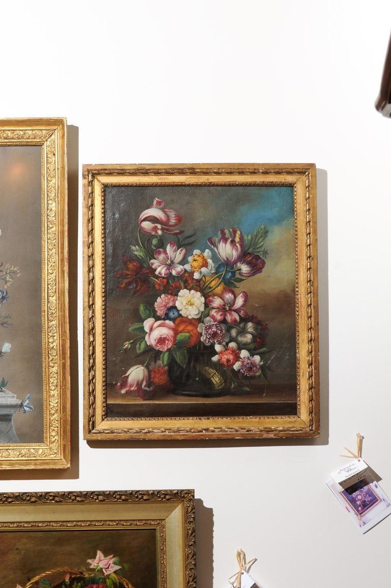A French oil on canvas still-life floral painting in the Dutch School style from the 18th century, in giltwood frame. Born in France during the Age of Enlightenment, this exquisite floral painting presents a strong influence from the Dutch School.