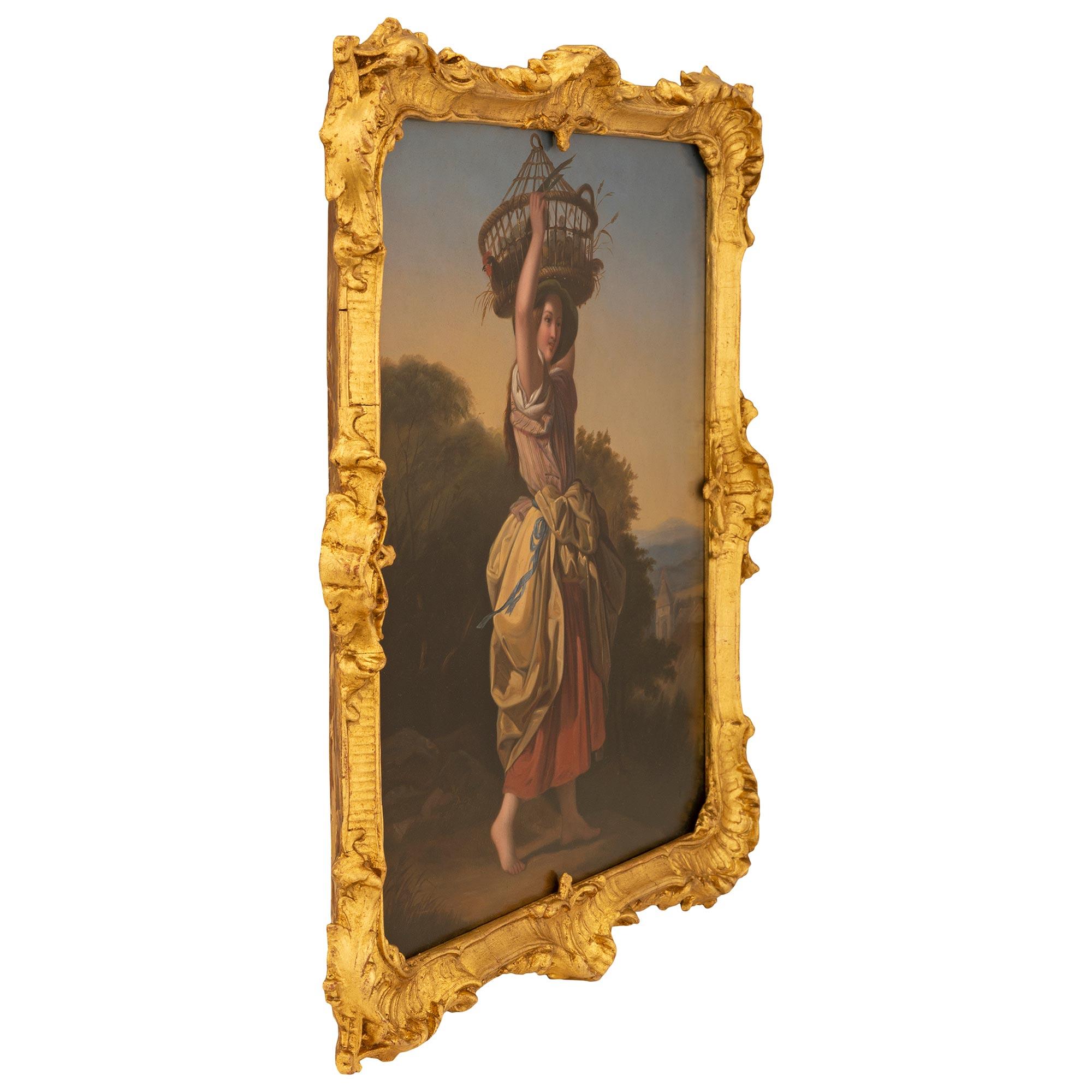 An exceptional French 18th century oil on copper painting in its original giltwood frame. The wonderfully executed painting depicts a beautiful young woman in a bonnet and flowing dress walking barefoot carrying a basket with chickens on her head