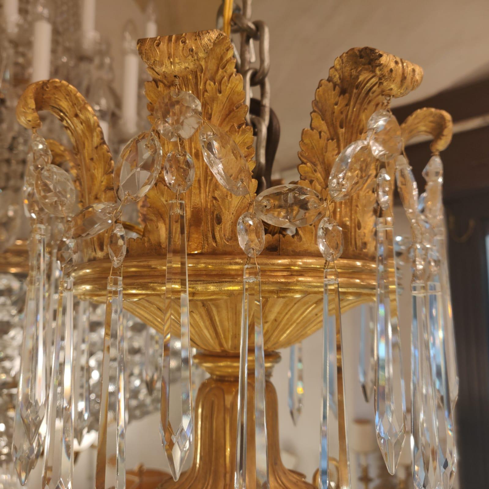 Exquisite French Directoire period, chandelier dated to the end of 18th century. The lower Montgolfier is centered by a richly chased acorn finial amidst foliate. Main band, supporting eight arms and sixteen palm-decorated pinnacles, features