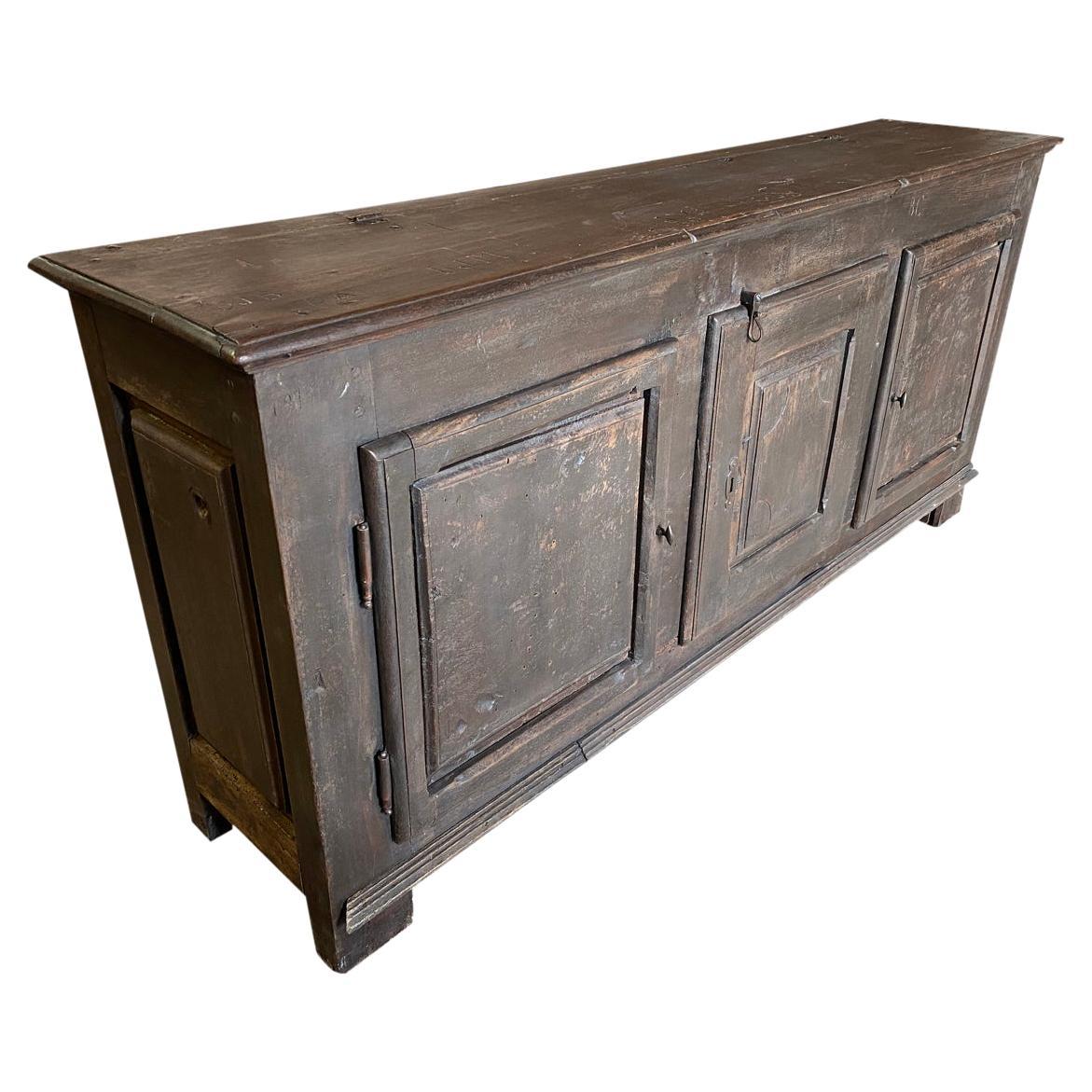 A very striking early 19th century Buffet from the Provence region of France. Soundly constructed from painted wood with 3 doors, molded door panels resting on block feet. There are charming inscriptions carved of the top surface from a later period