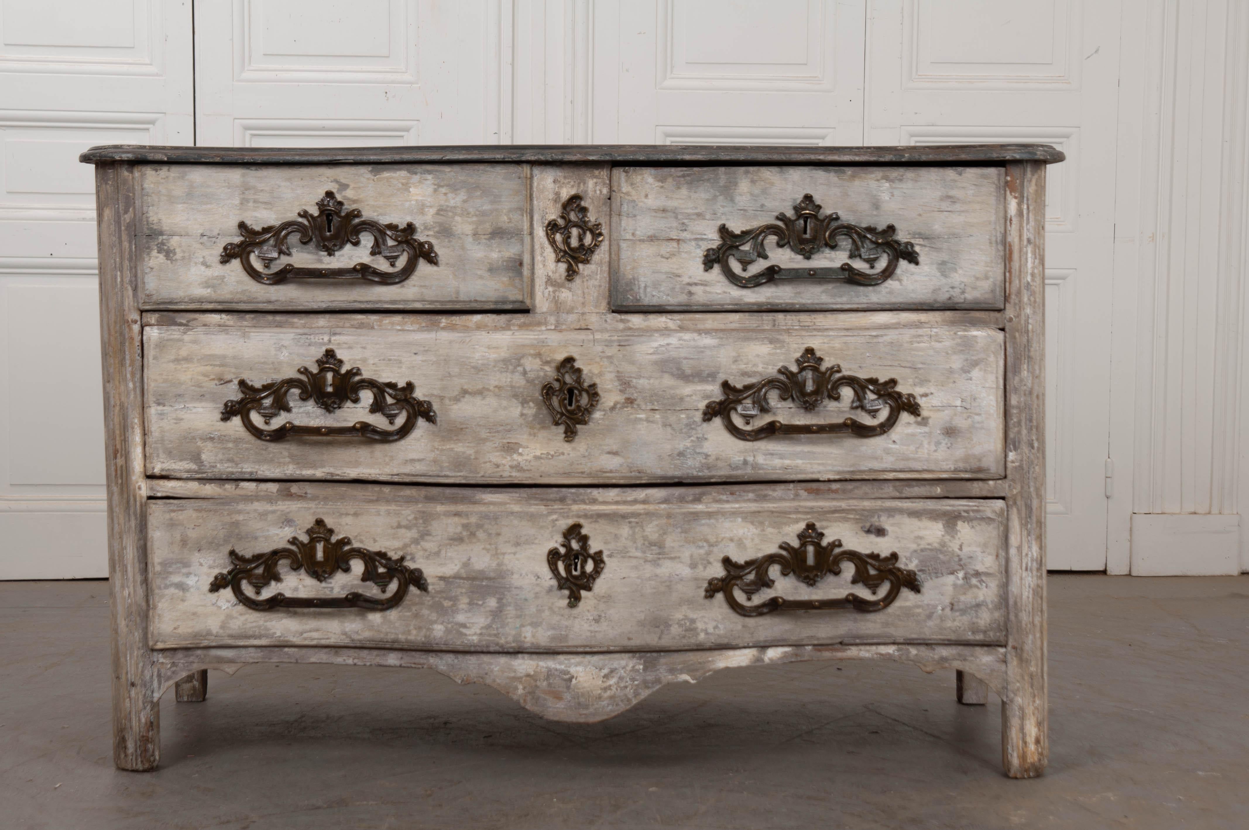 An exceptional Parisian commode, with painted finish, from 18th century, France. This four-drawer antique case piece features a shapely form and an outstandingly well-patinated finish. All drawers are equipped with large, decorative bronze pulls.