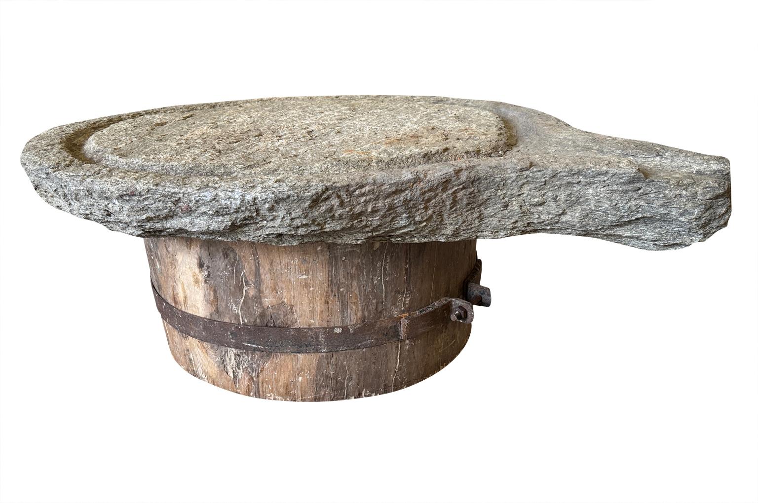 A terrific 18th century Coffee Table - Table Basse from the South of France.  Beautifully constructed from a mid-18th century stone Pressoire - Press and a substantial wood base with an iron fitting.  Perfect for any relaxed interior or exterior.
