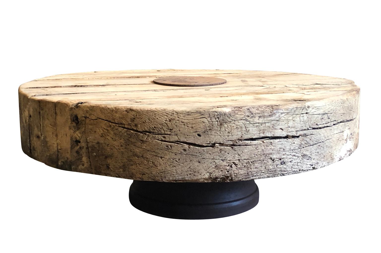 Sensational coffee table - constructed from an 18th century wine press - Pressoire - from a vineyard in the Provence region of France. The press sits sturdily on an iron base. Terrific patina. A tremendous piece for any interior or garden.