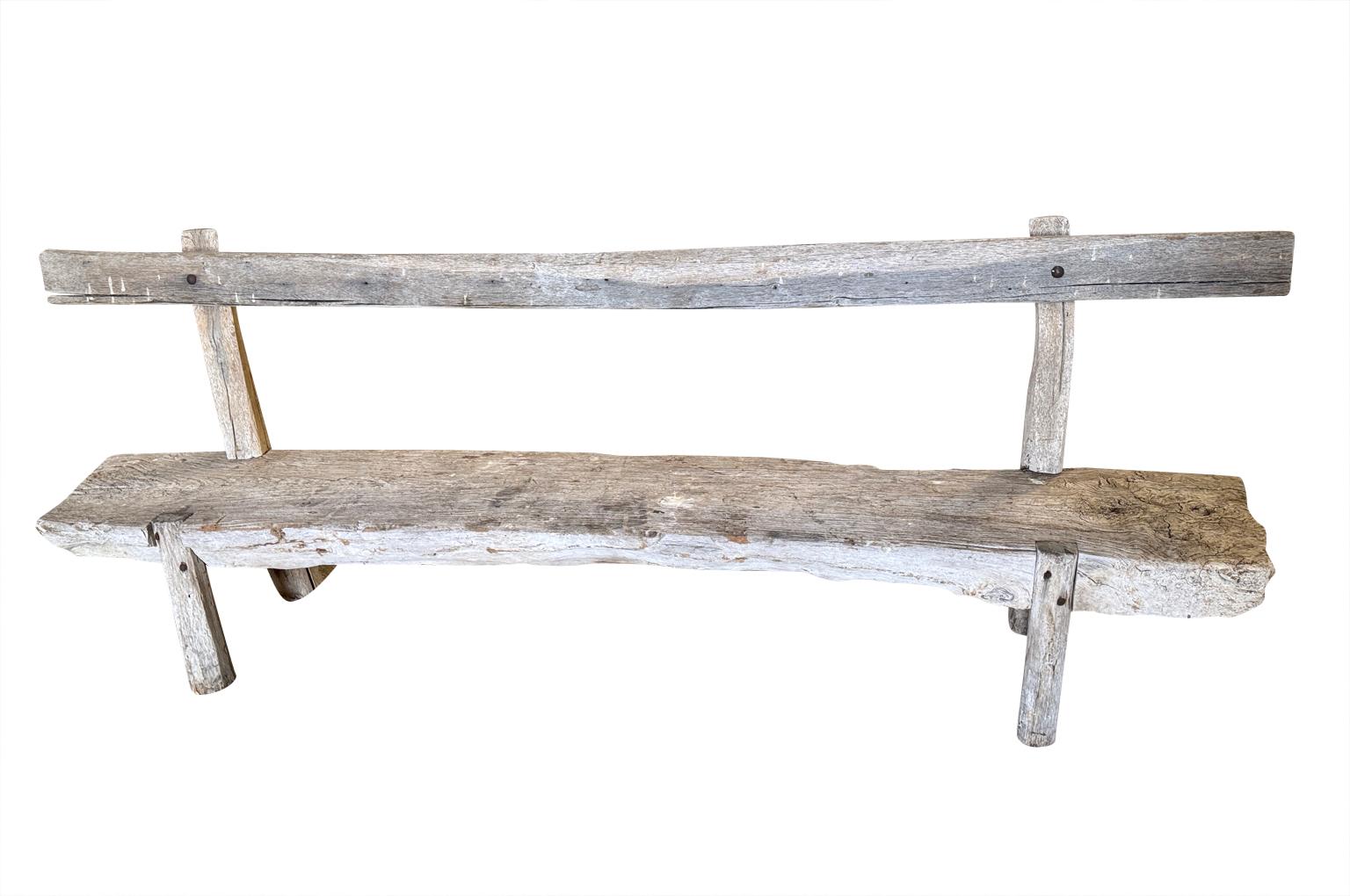 A wonderfully charming 18th century primitive Bench from the Provence region of France.  Soundly constructed from naturally washed oak and polar with a slat back and thick plank seat.  Super patina. The seat height is 14 1/2