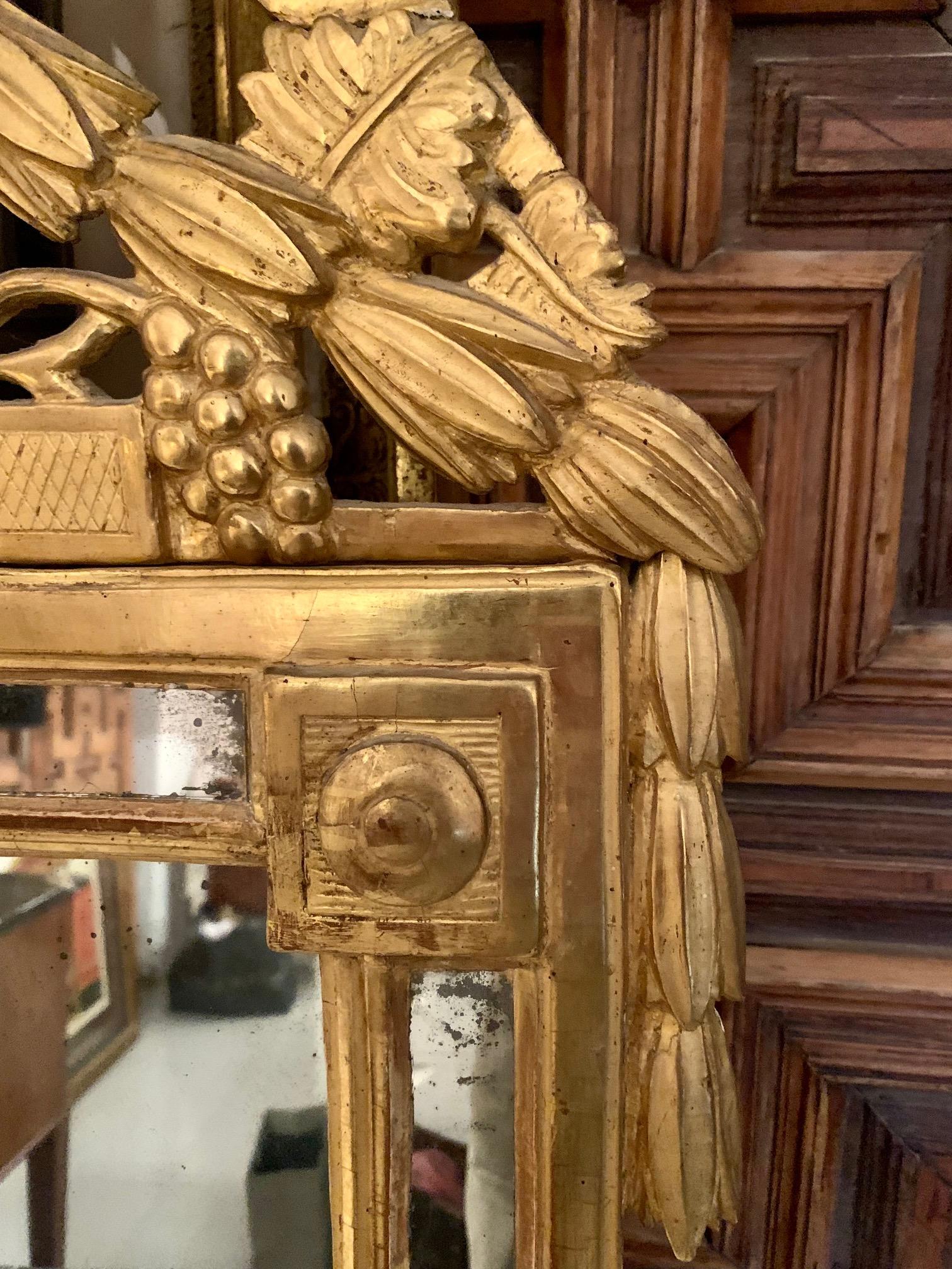 18th century / Louis XVI century French wall mirror, Provençal gilded wood with a double frame made up of mirror plates, framing another mirror. in the upper part it ends with another small oval mirror and 