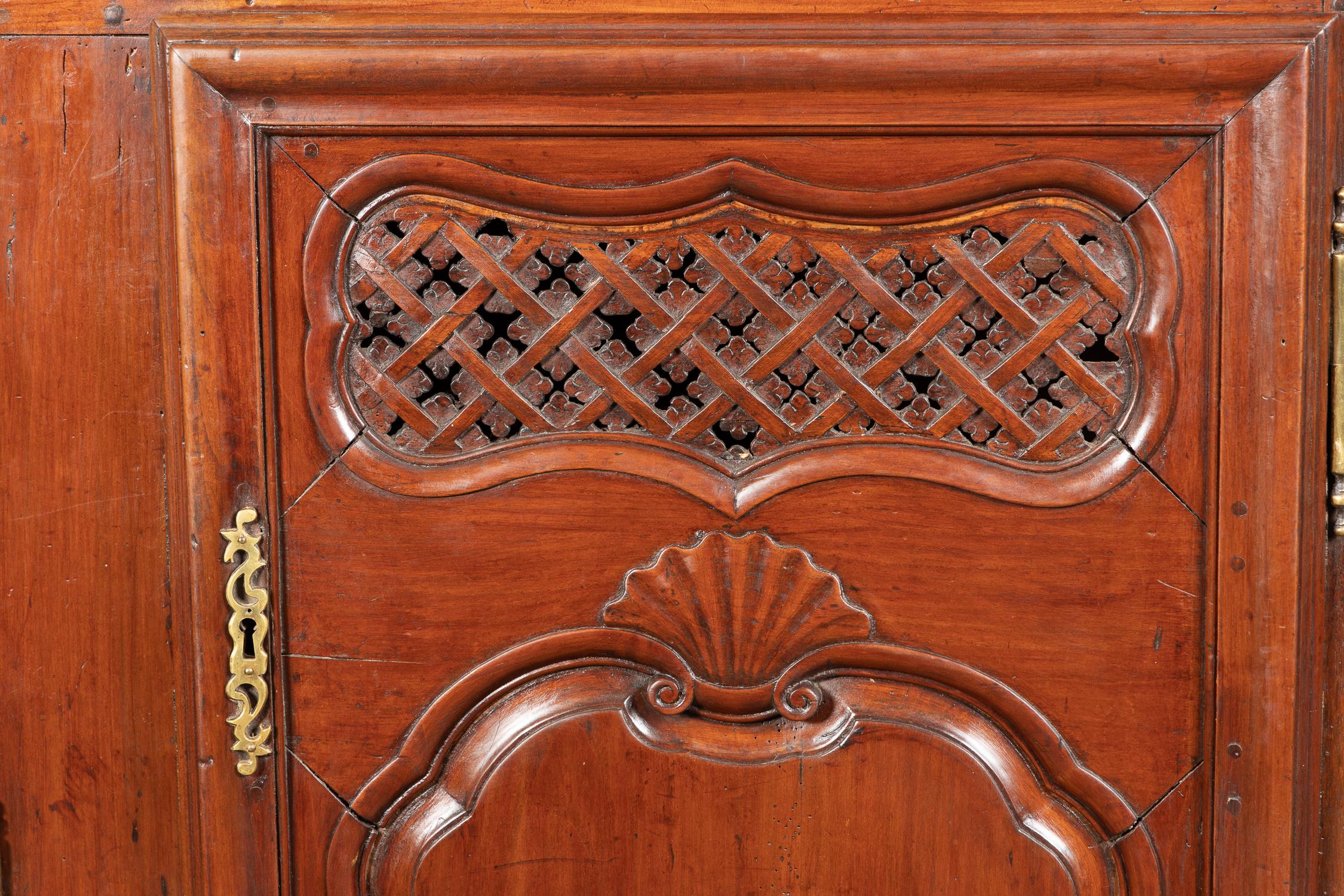 This beautiful French Regence buffet is carved from rare, gorgeous padauk wood.  The piece dates back to the 18th century and offers three doors. The two side doors flank a center door, above which sits a center drawer. The piece plays host to