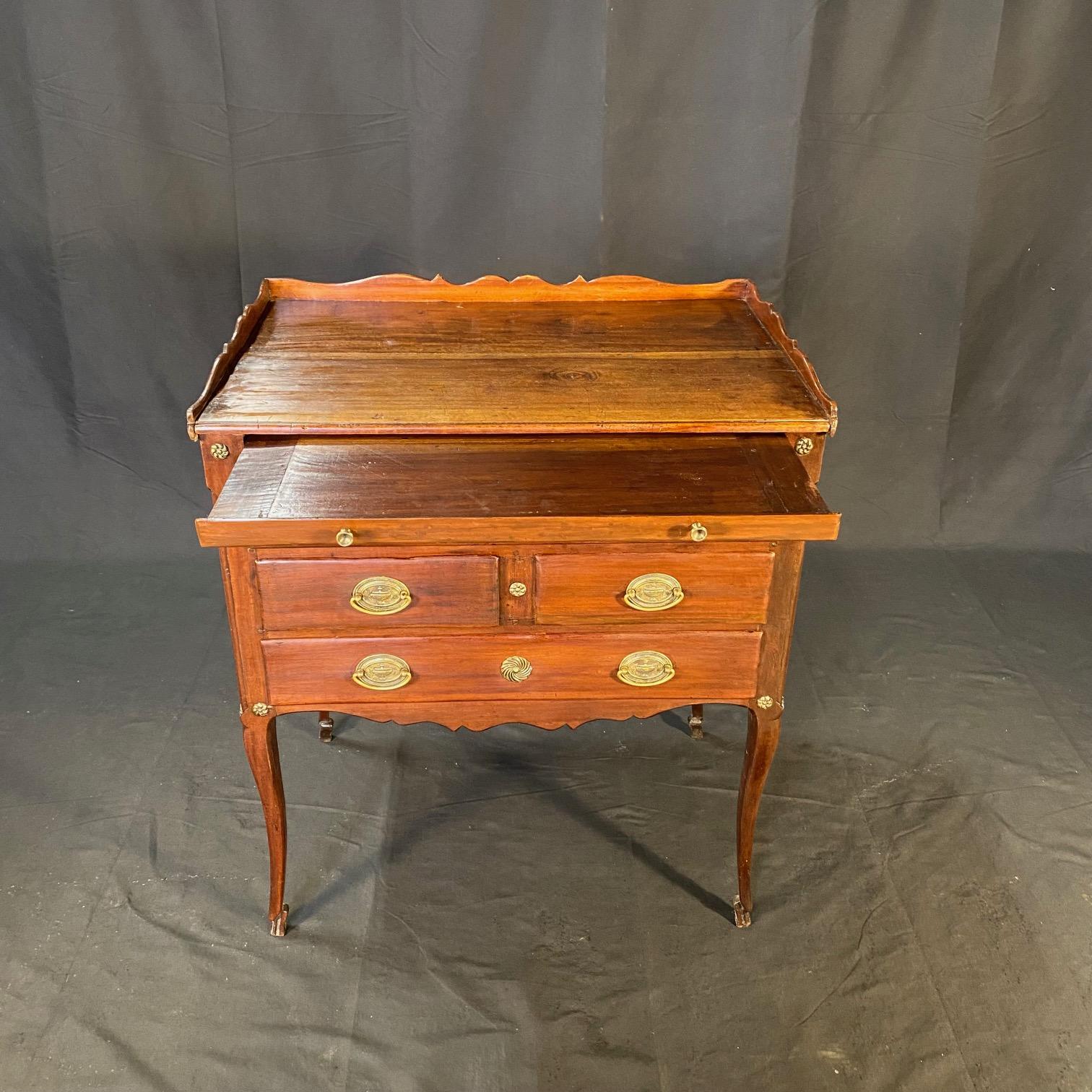 Bellissimi dettagli in questo gioiello di cassettiera! Questo comodino francese Regency a 5 cassetti è stato trovato in Francia, fuori Parigi, ed è dotato anche di un'anta estraibile per scrivere sopra i cassetti. Tutti i cassetti sono dotati di