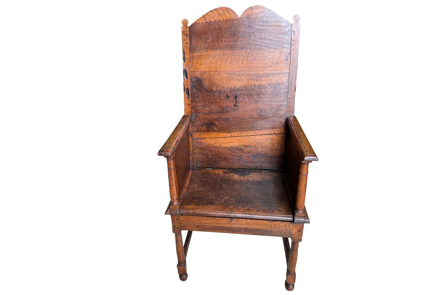 A very handsome mid-18th century Armchair from the South of France.  Soundly constructed from beautiful walnut.  The seat lifts to expose a hidden compartment for storing a Bible.  Wonderful patina. 