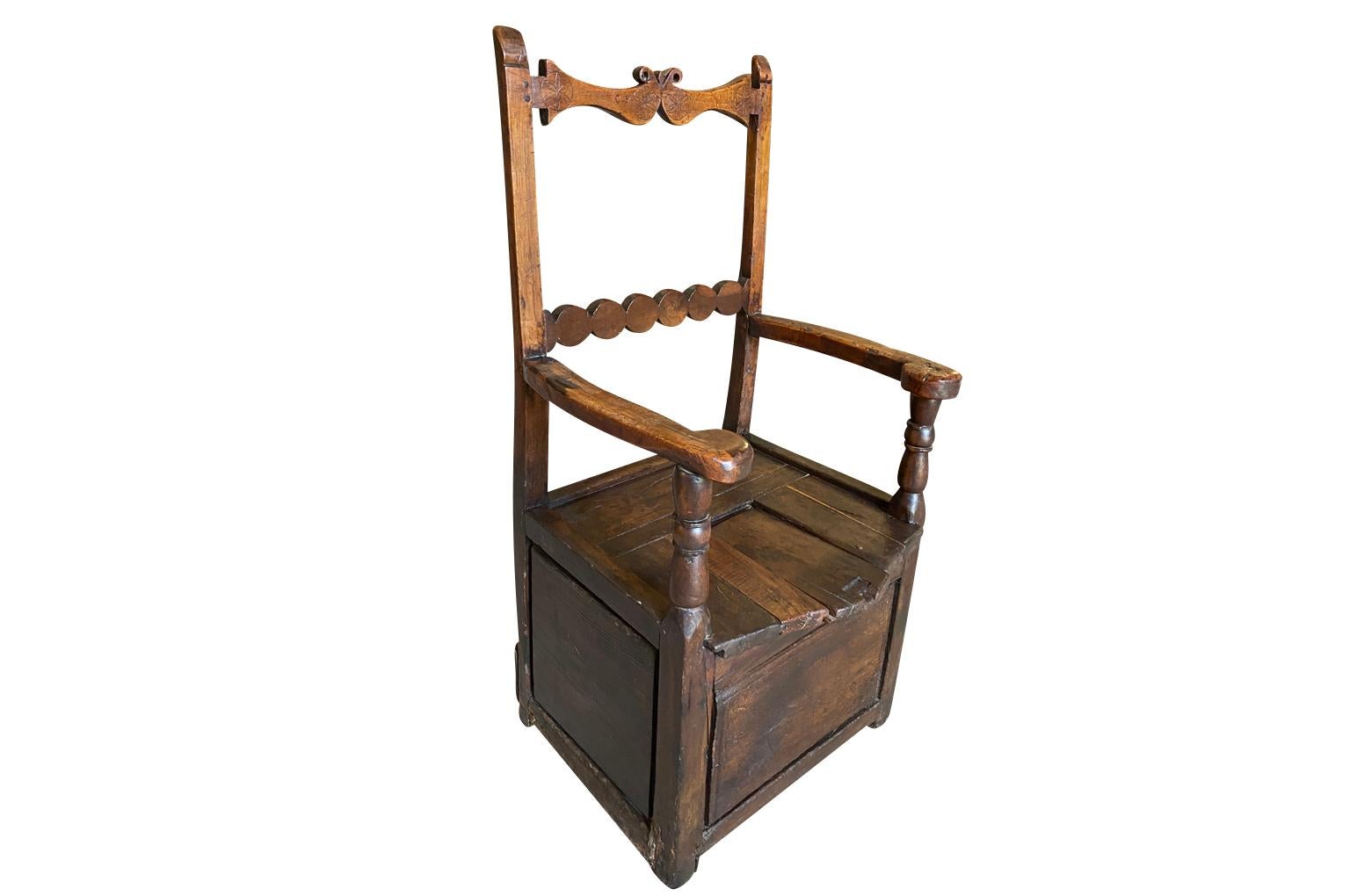 A delightful 18th century Arte Populaire Salt Box Chair from Auvergne, France.  Soundly constructed from richly stained oak with nicely carved back and a removable slat on the seat for the salt storage.  Super patina with great character.  The seat