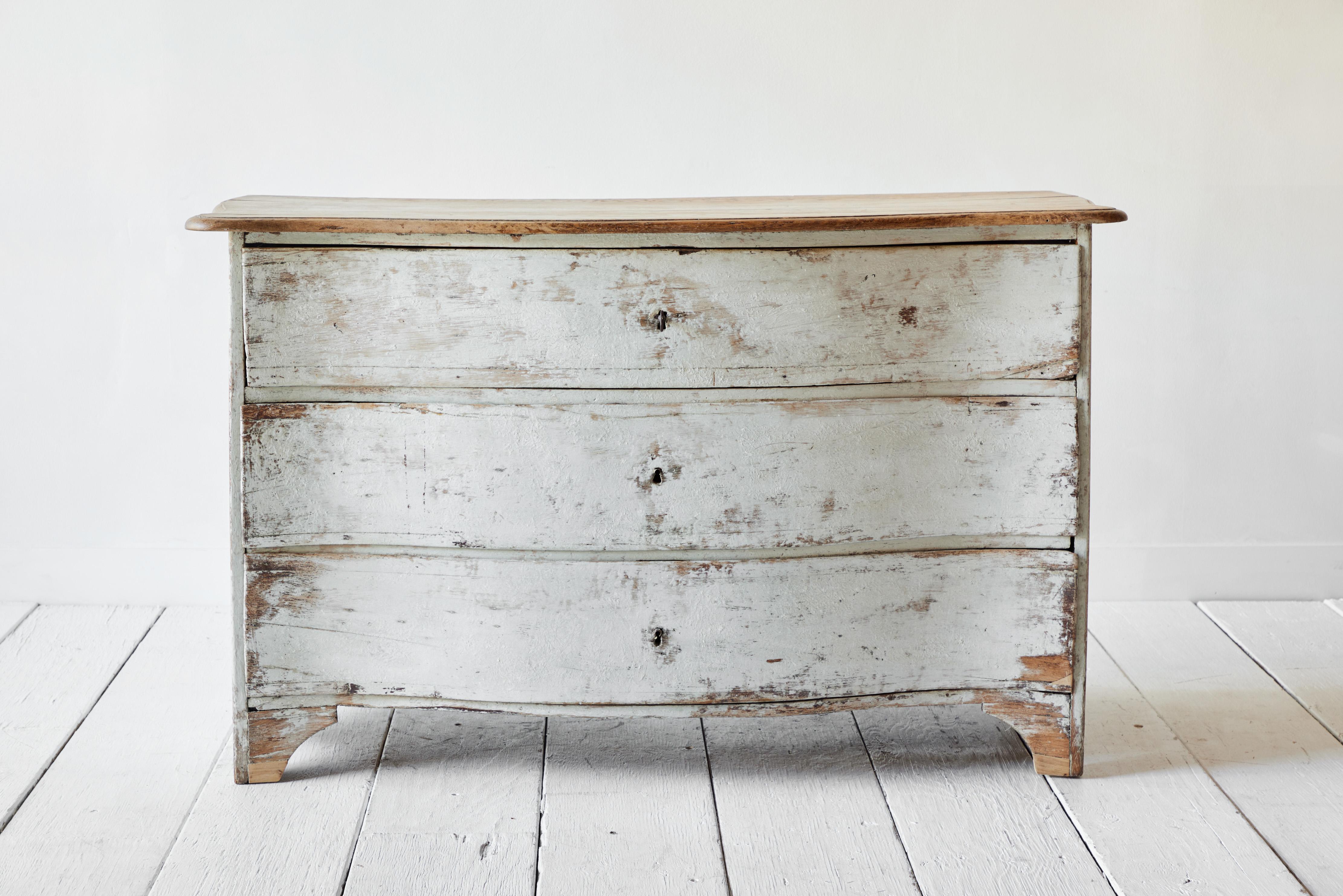 French country commode with a serpentine front. This stunning piece has a natural wood top, rustic painted white facade and three ample drawers for storage.
   
  