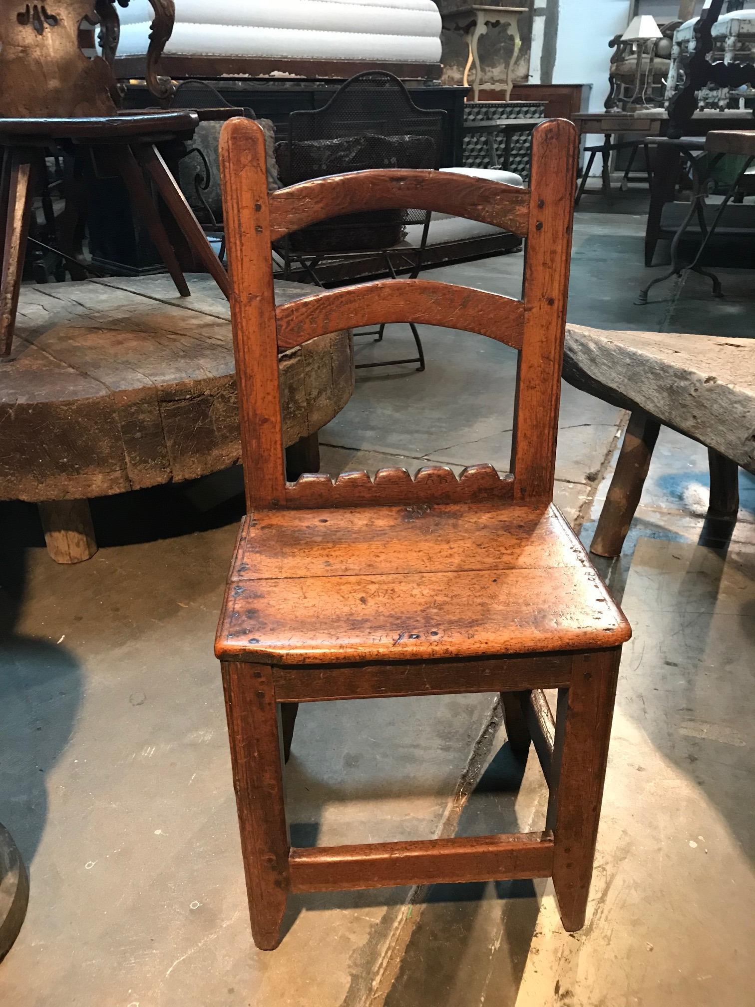 An absolutely charming 18th century diminutive side chair from Queyras - in the French Hautes Alpes. Wonderfully constructed from richly stained pine. Terrific patina - deep and luminous. The initials 