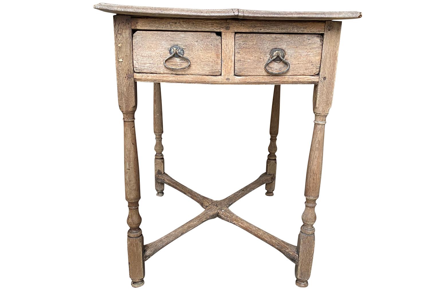 A very lovely 18th century side table from the South of France. Wonderfully constructed from oak with double drawers, nicely turned legs, X stretcher and beautiful hardware. A very charming piece with wonderful patina.