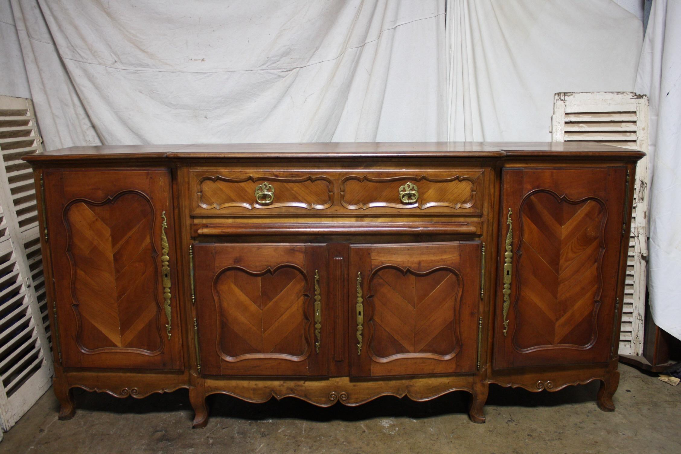 This is a Long and high sideboard, very strong and powerful standing, the parquetry on the doors gives a character, very well built, with a slider under the big drawer. Originally the slider was used to put dishes, bread or cheese.
Beautiful piece.