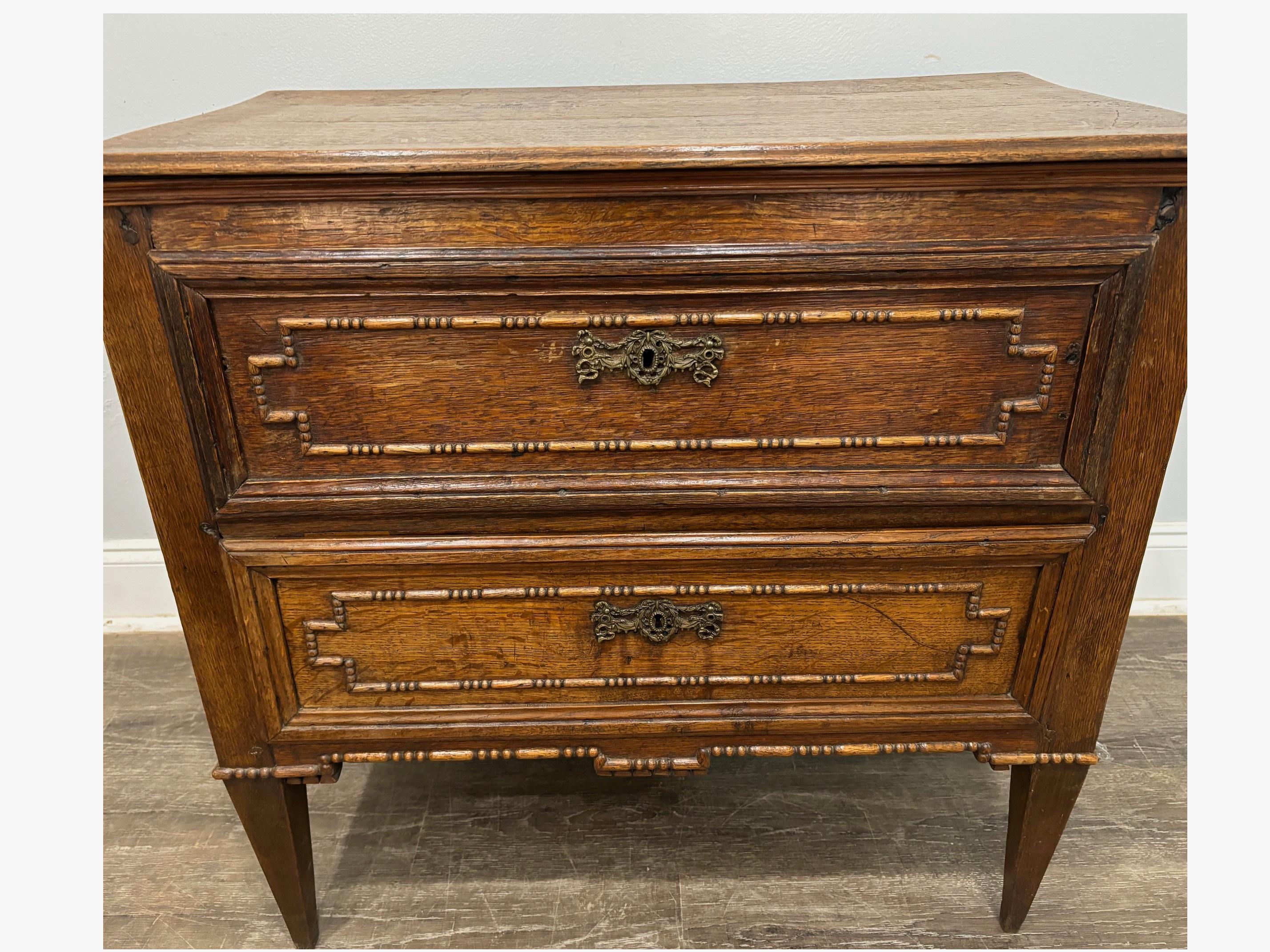 This chest is made of oak and is nicely carved. It wears a mixture of dressy and rustic.