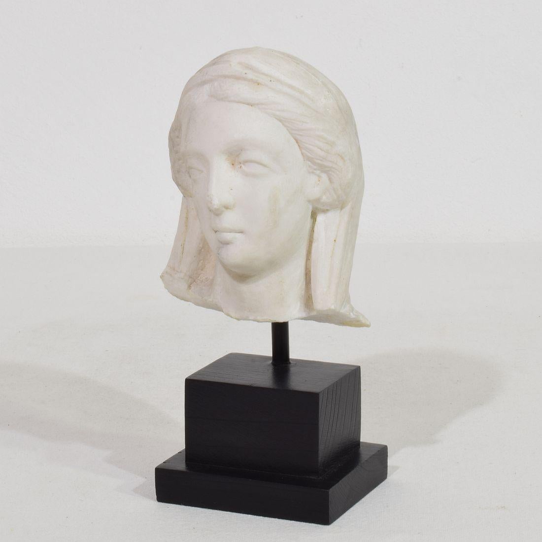 Beautiful hand carved marble head of a Madonna. 
Unique period piece with a beautiful weathered patina.
France, circa 1750.
Weathered 
Measurements include the wooden base.