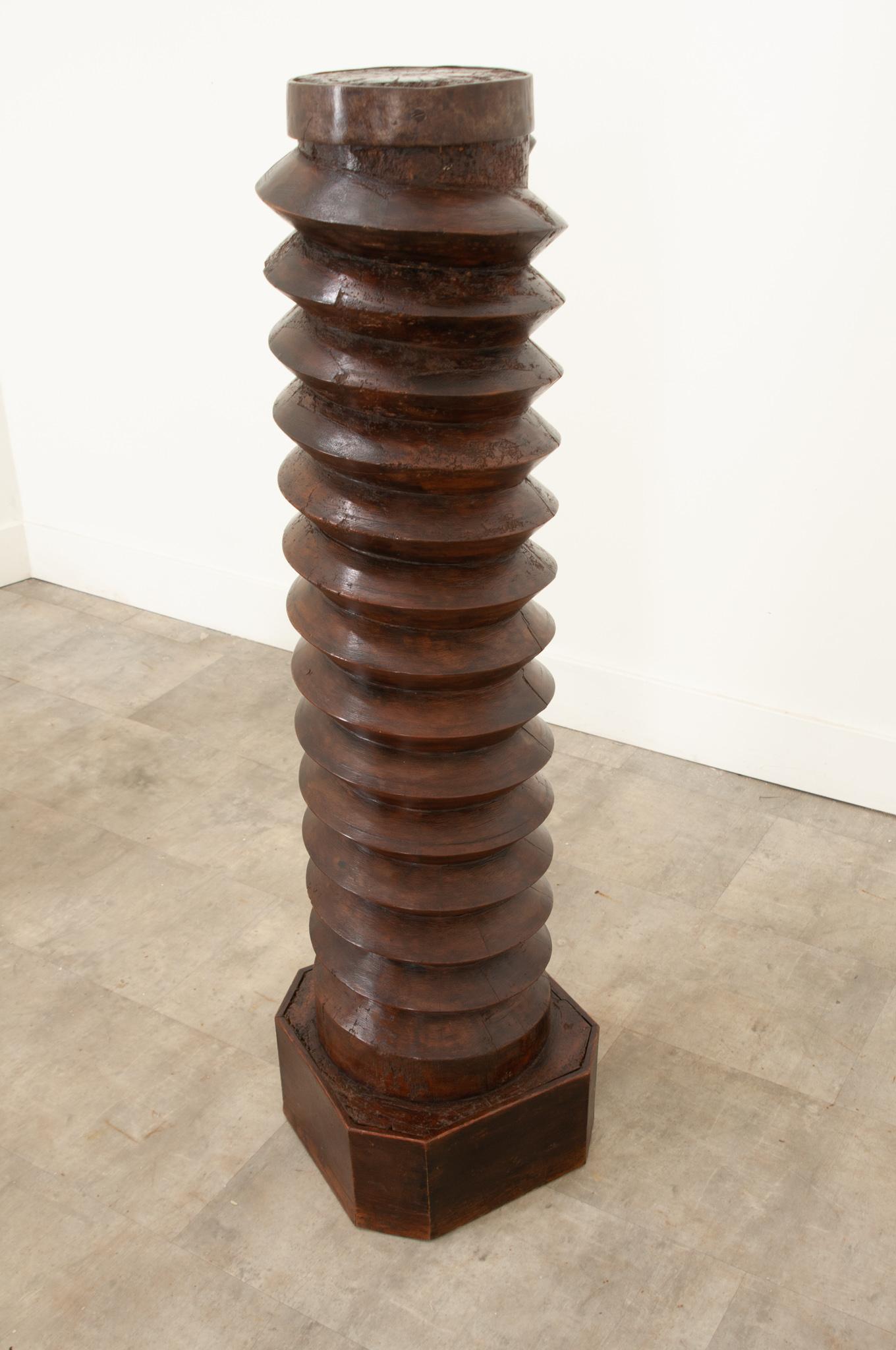 This wonderfully aged 18th century grape press screw – from a winery in France – has been converted into a pedestal with a circular top and octagonal base added later. The shaft would have driven a large stone wheel downward, crushing and squeezing