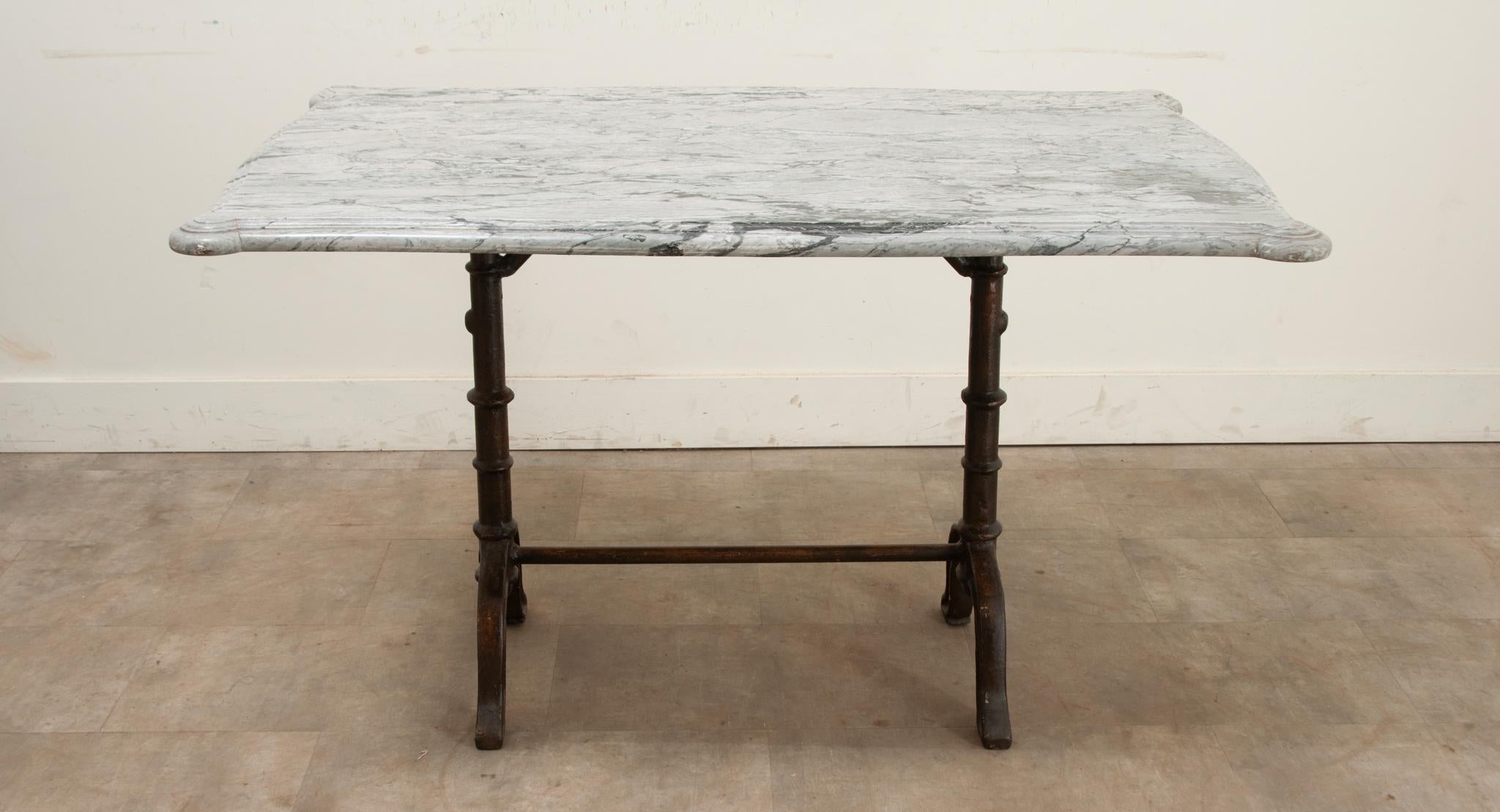 A beautiful garden dining table married together over time. The top is older than its base and is from the 1700’s. It’s a thick slab of marble curved on all four sides and has pronounced rounded corners. The base is made of heavy cast iron and is