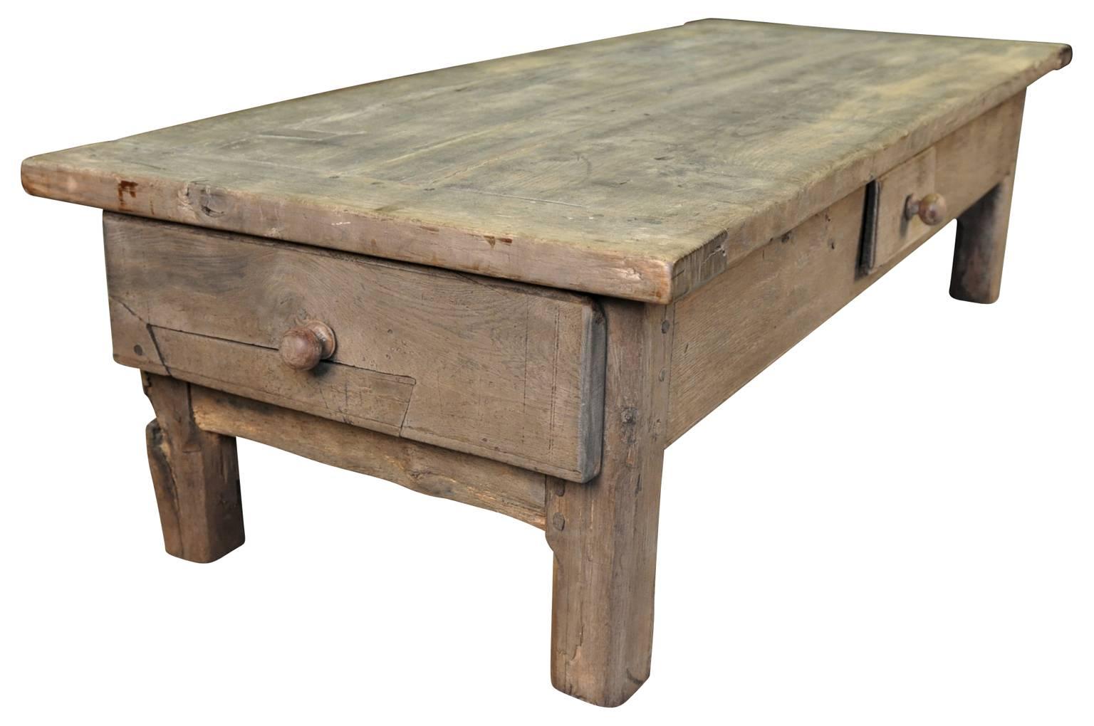 A very charming and primitive 18th century farm table - now as a coffee table - table basse. Soundly constructed from washed oak. A perfect coffee table for any casual living area or porch.