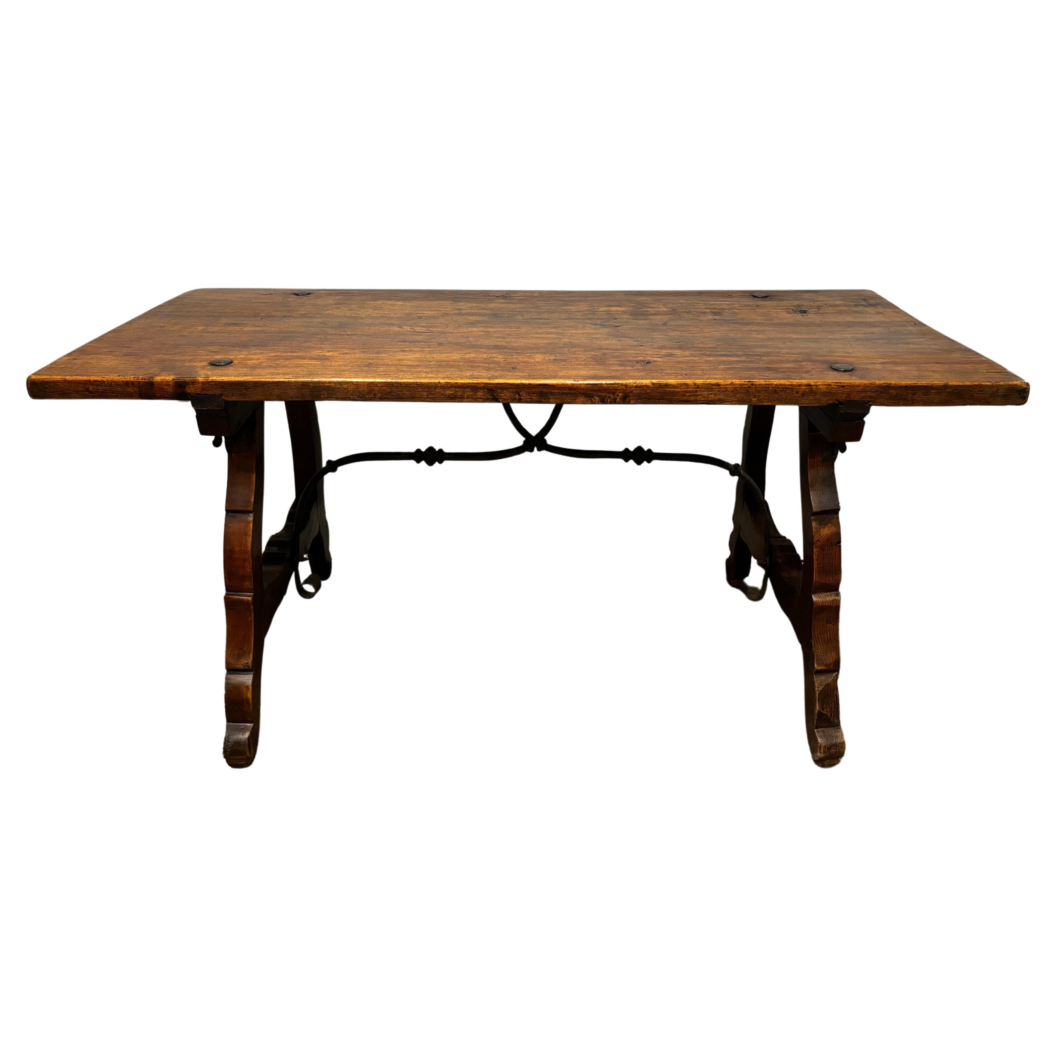 This wonderful table can be used as well as a desk. It has an amazing work of wrought iron at the base and the top.