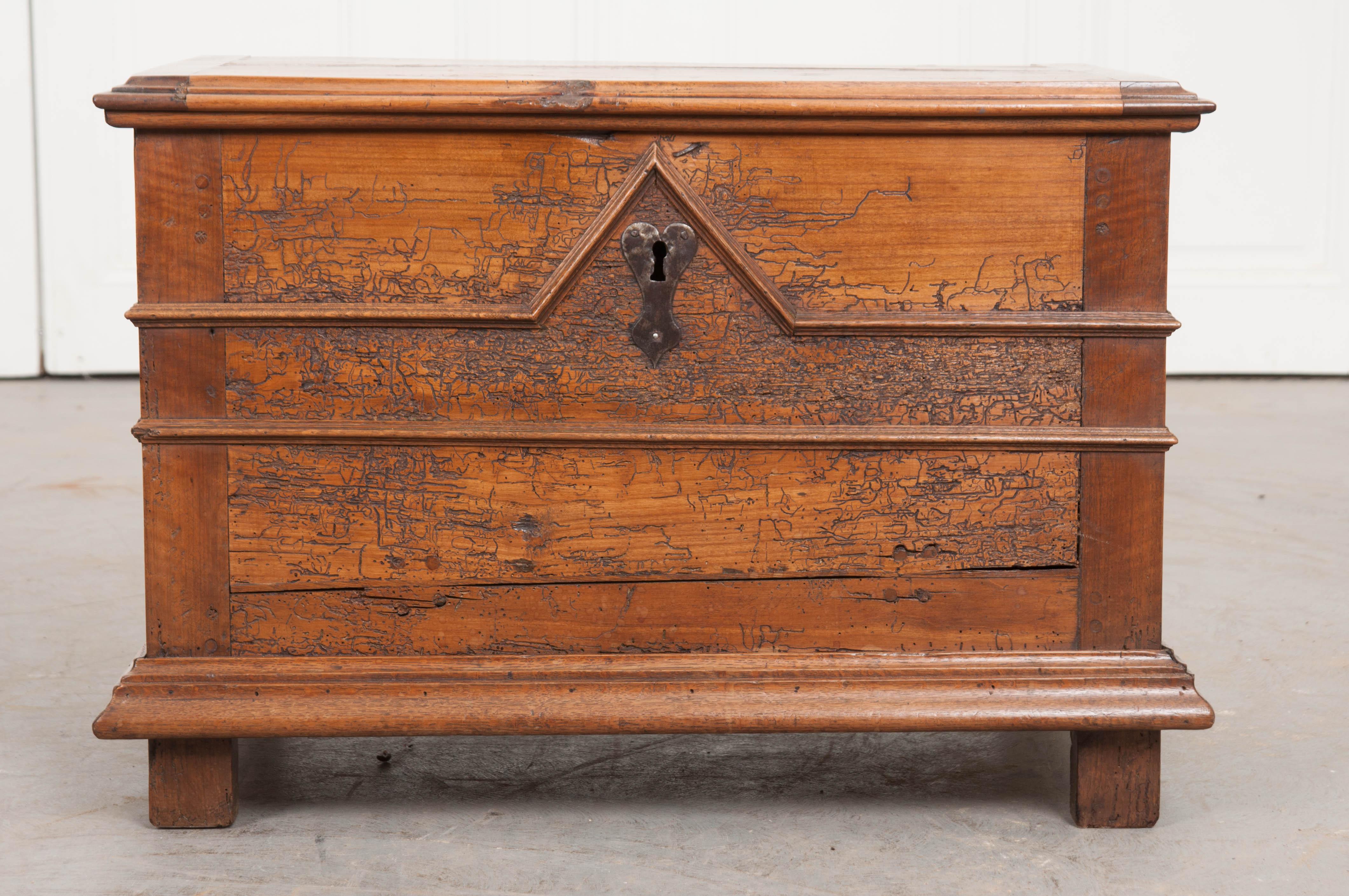 A smaller walnut trunk, made with transitional styling in France, circa 1780. This little chest combines stylings of English Jacobean and French Louis XIII furniture. The hinges and escutcheon are both made of hand forged iron that provide even more
