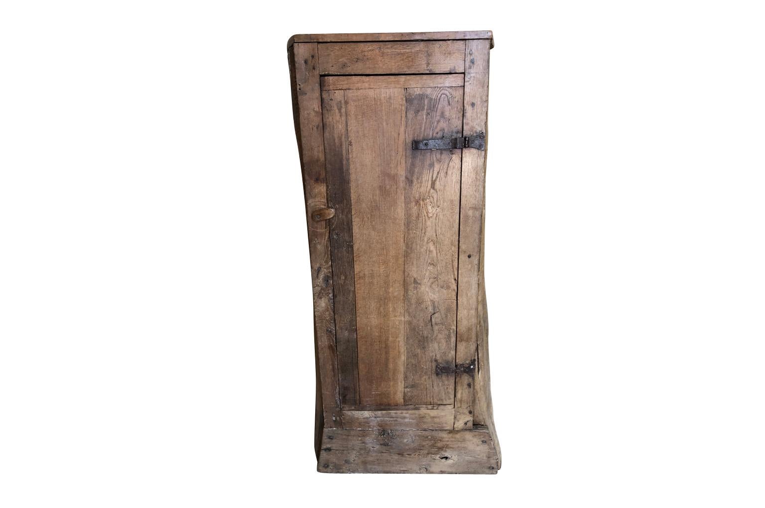 A very charming - Arte Populaire - Folk Art - 18th century French cabinet made from a hollowed out chestnut tree. The interior has shelves and ample storage space. A delightful hand crafted piece perfect for any casual living space.