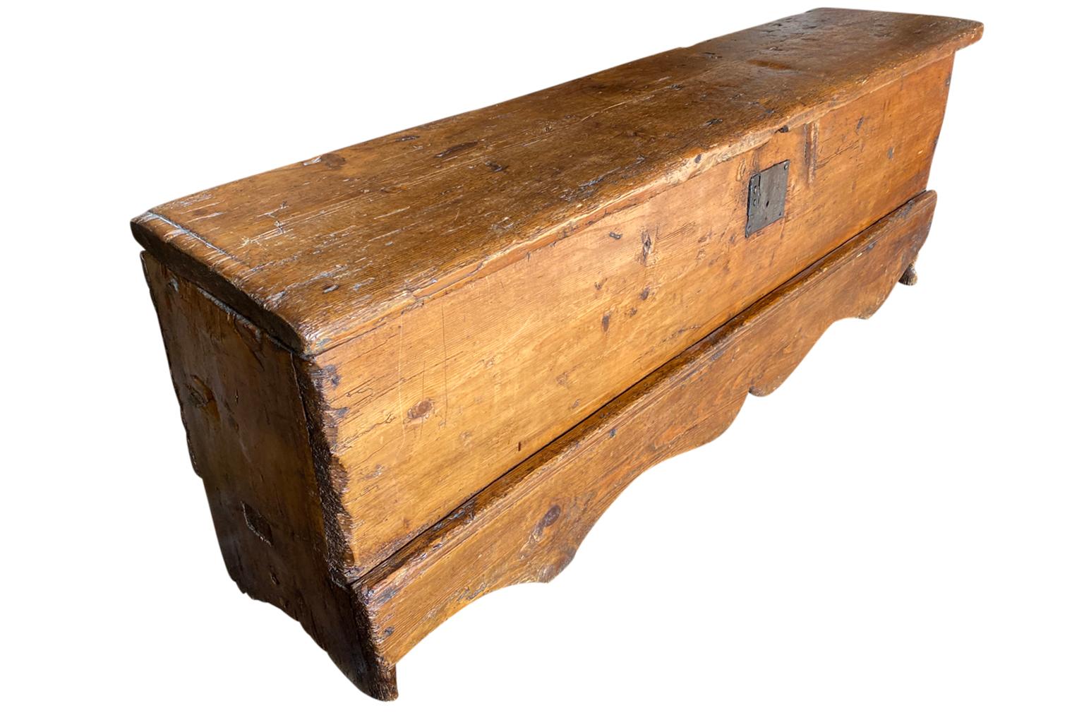 A very handsome 18th century Trunk from the South of France. Soundly constructed from richly stained pine with charming scalloped shaped apron and an interior storage compartment. Beautiful at the base of a bed or under a picture window. Lovely
