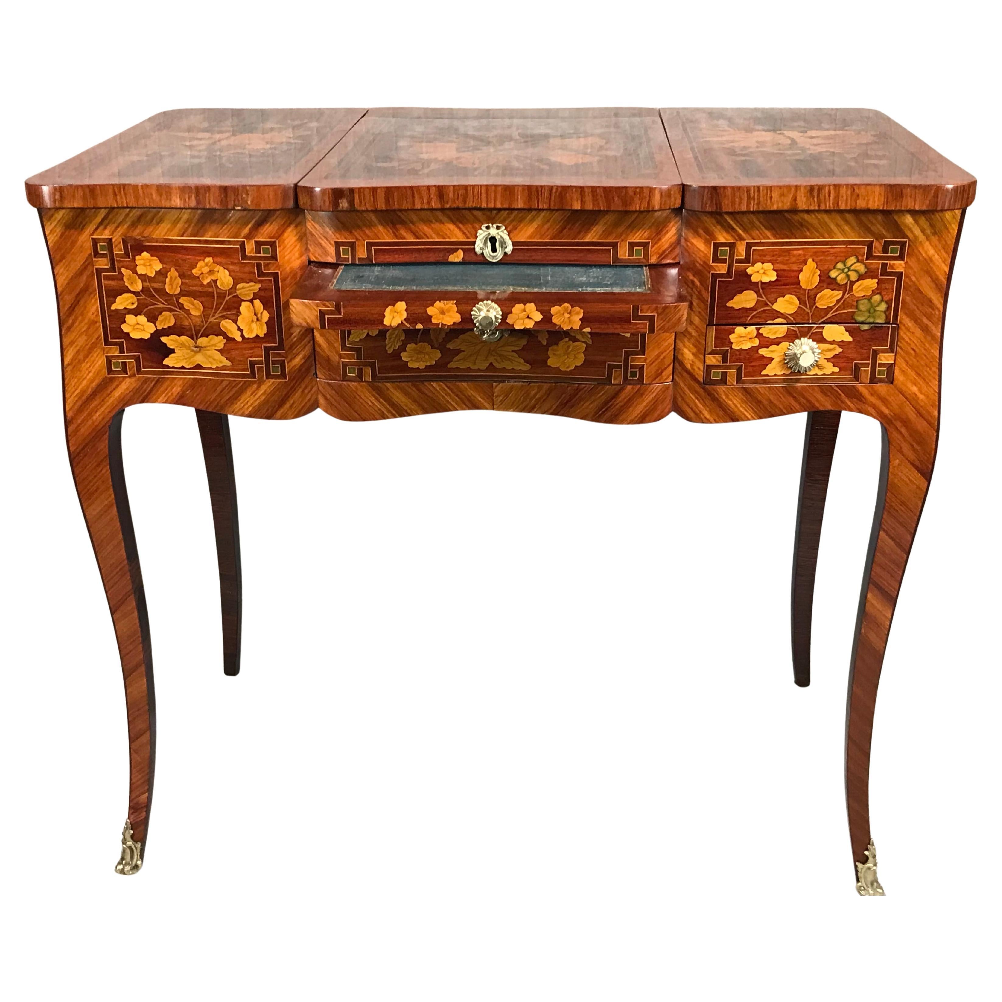 This exquisite unique Louis XV vanity, or poudreuse, dates to the 1760s and originates from France. The dressing table features breathtaking marquetry décor, elegant brass fittings, and intricate detailing with floral motifs and musical