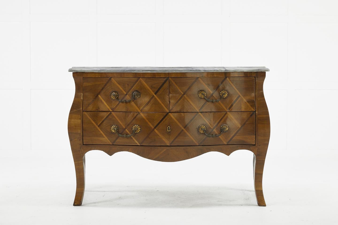 Shapely French 18th century walnut bombe commode with cabriole legs and marble top. Attractive diamond pattern parquetry inlay. Nice shape and form with decorative handles.
 