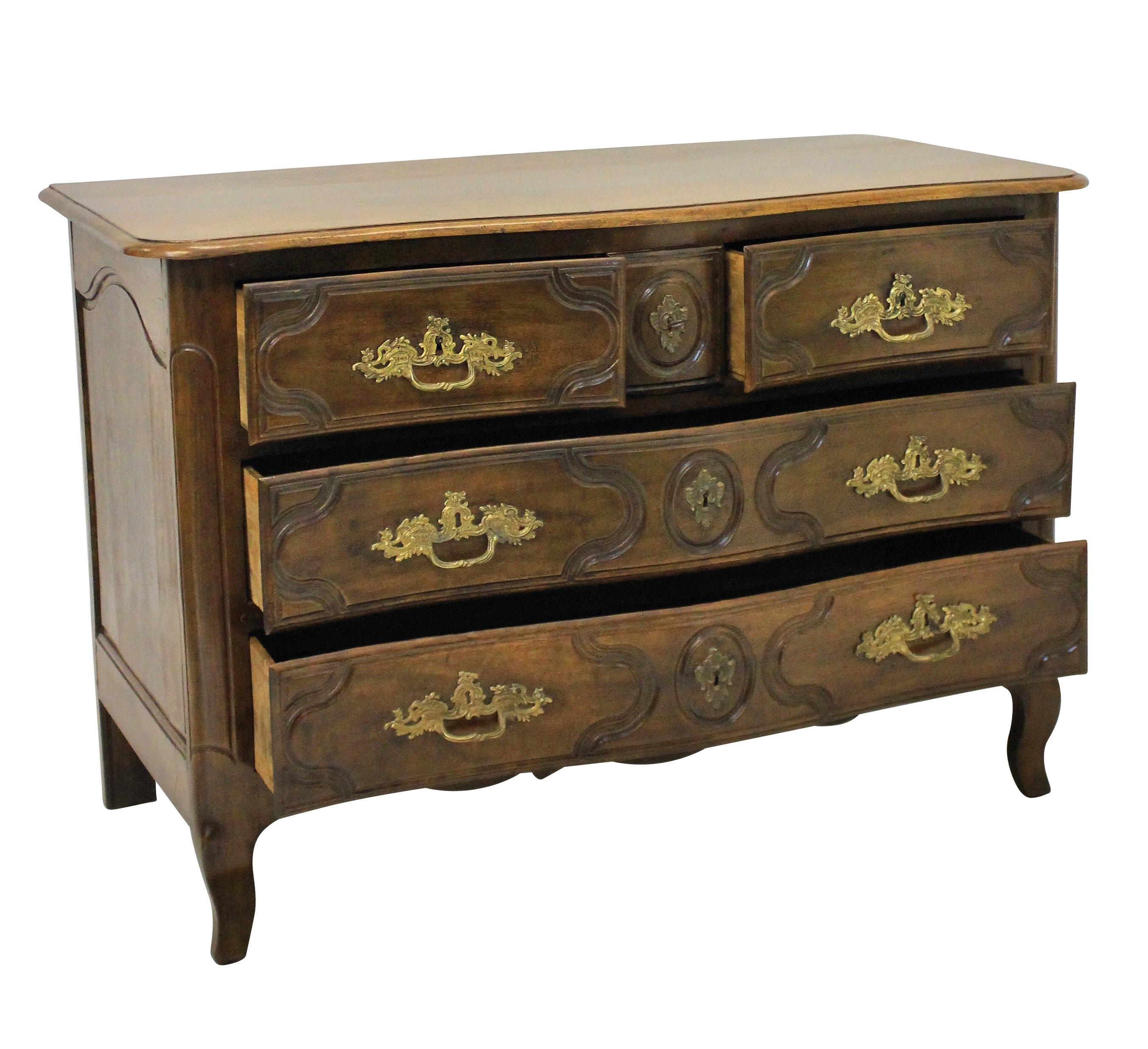 An 18th century French Provincial walnut commode, with serpentine front and five drawers. The original handles in gilt bronze, overall with a great patina.

  